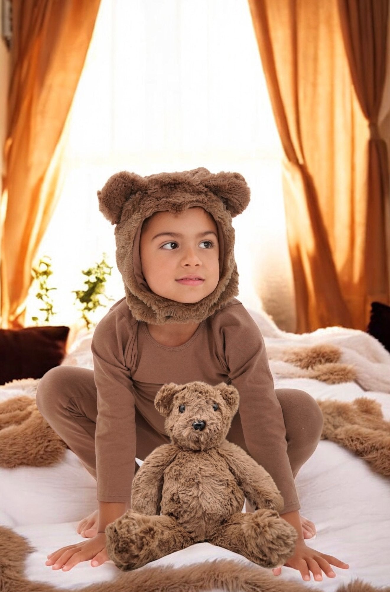 Child wearing a non-toxic bear costume with eco-friendly materials, holding a teddy bear.