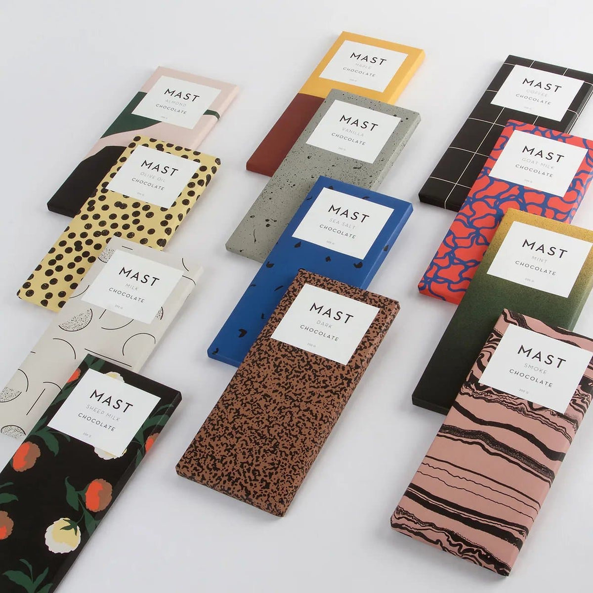 Assorted organic dark chocolate bars arranged in rows, including unique flavors and patterns.