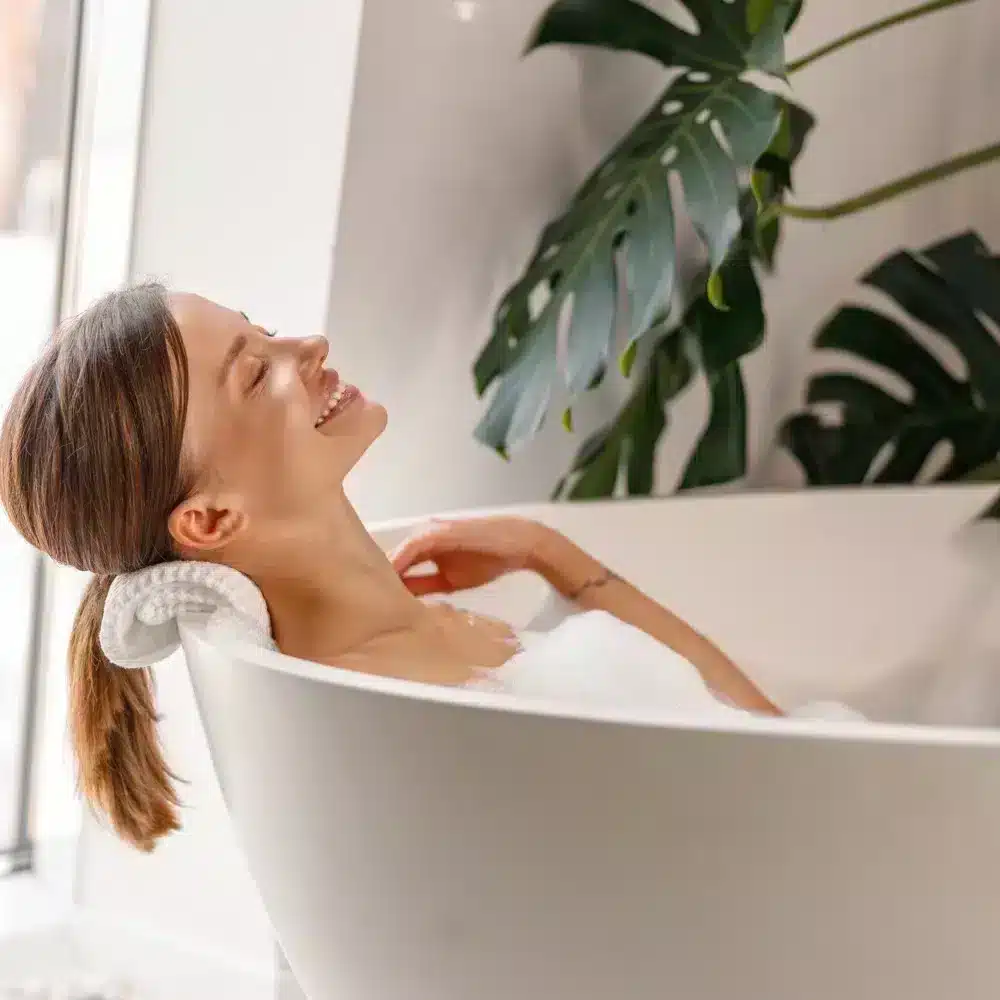 Woman in bubble bath with greenery