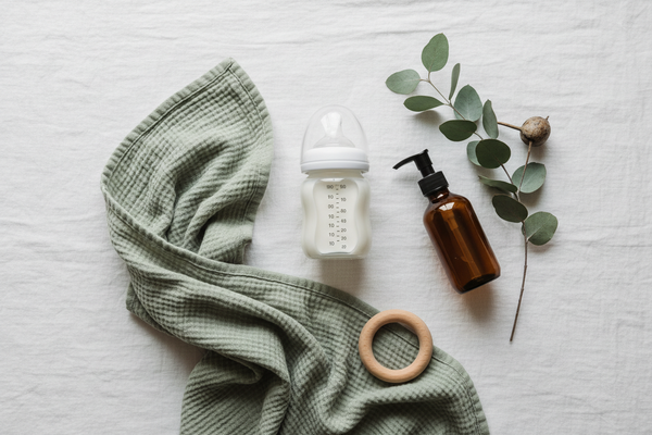Several natural and non toxic pregnancy and baby products sitting on a white sheet.