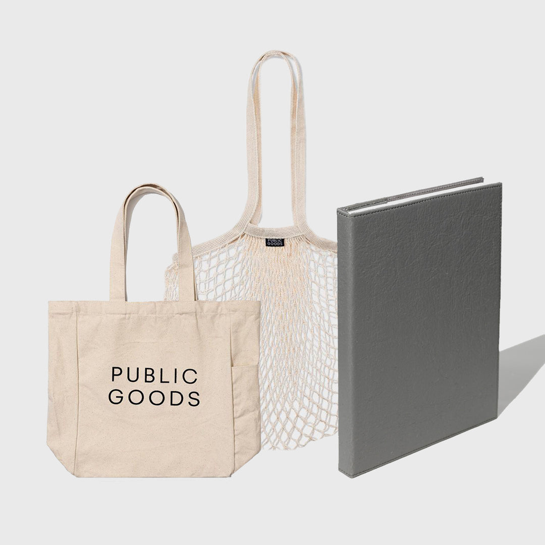 Three bags including a 'Public Goods' tote, a mesh bag, and a gray book on a light gray background
