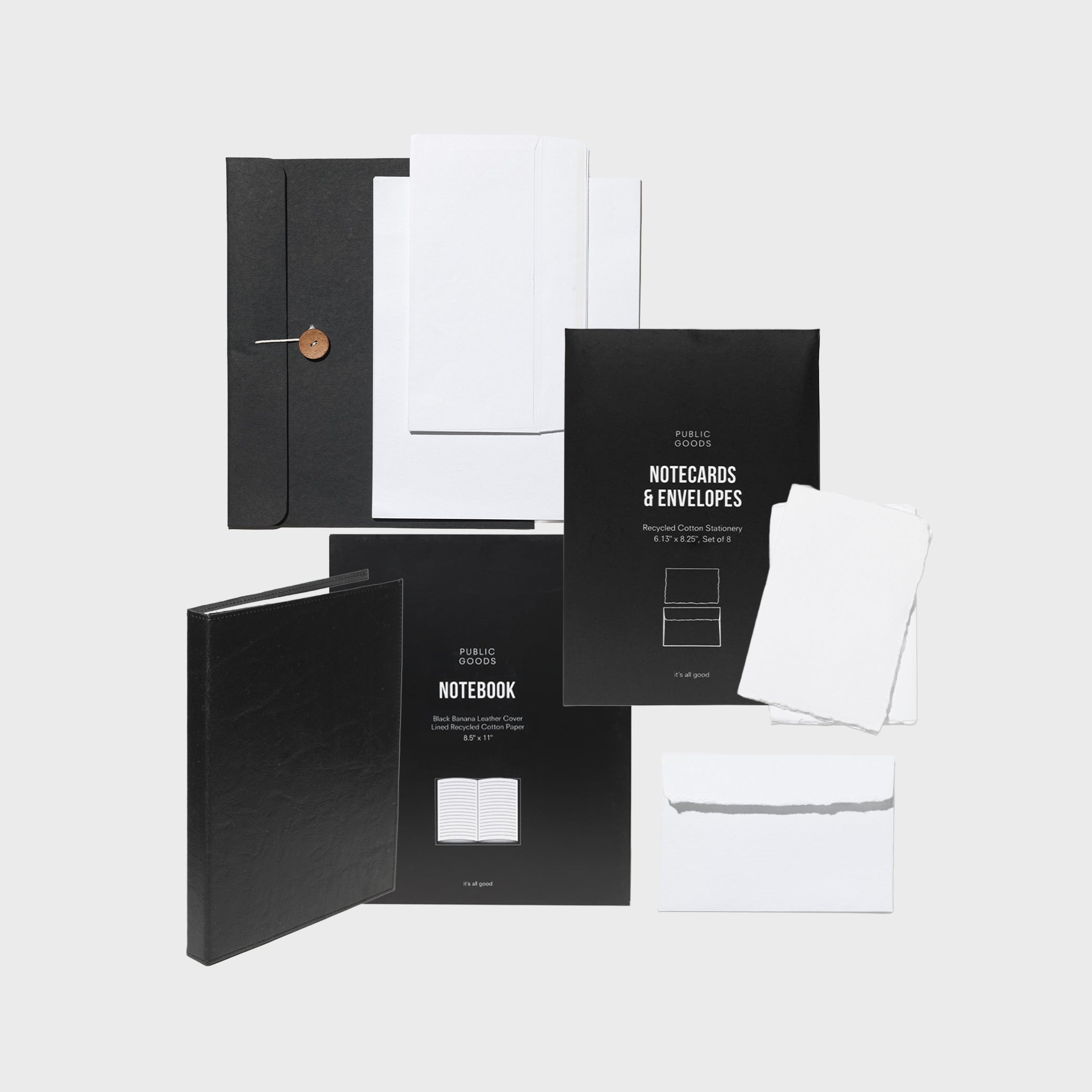 Black notebooks and white envelopes on a light gray background