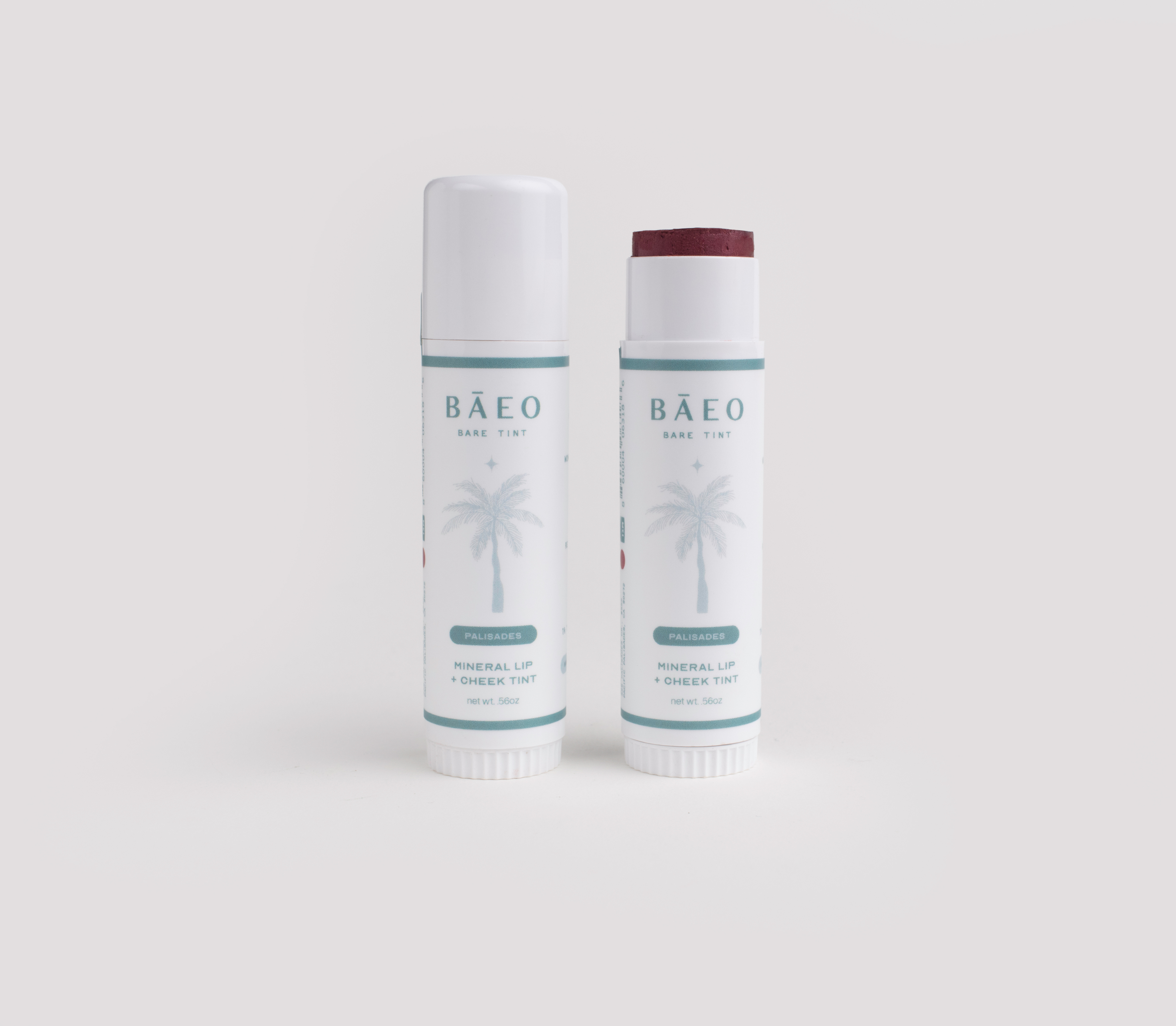 Two Bäeo lip balm tubes on a light gray background