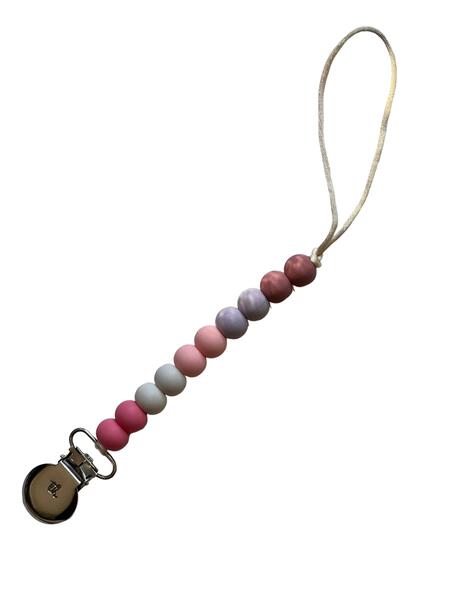 Beaded pacifier clip with a button on a white background