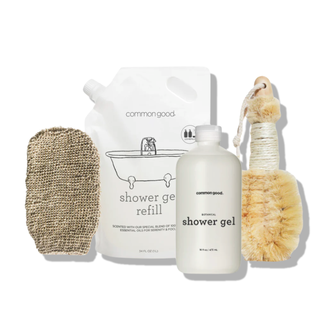 Set of common good shower gel products including a bottle, refill pouch, and scrubber on a white background