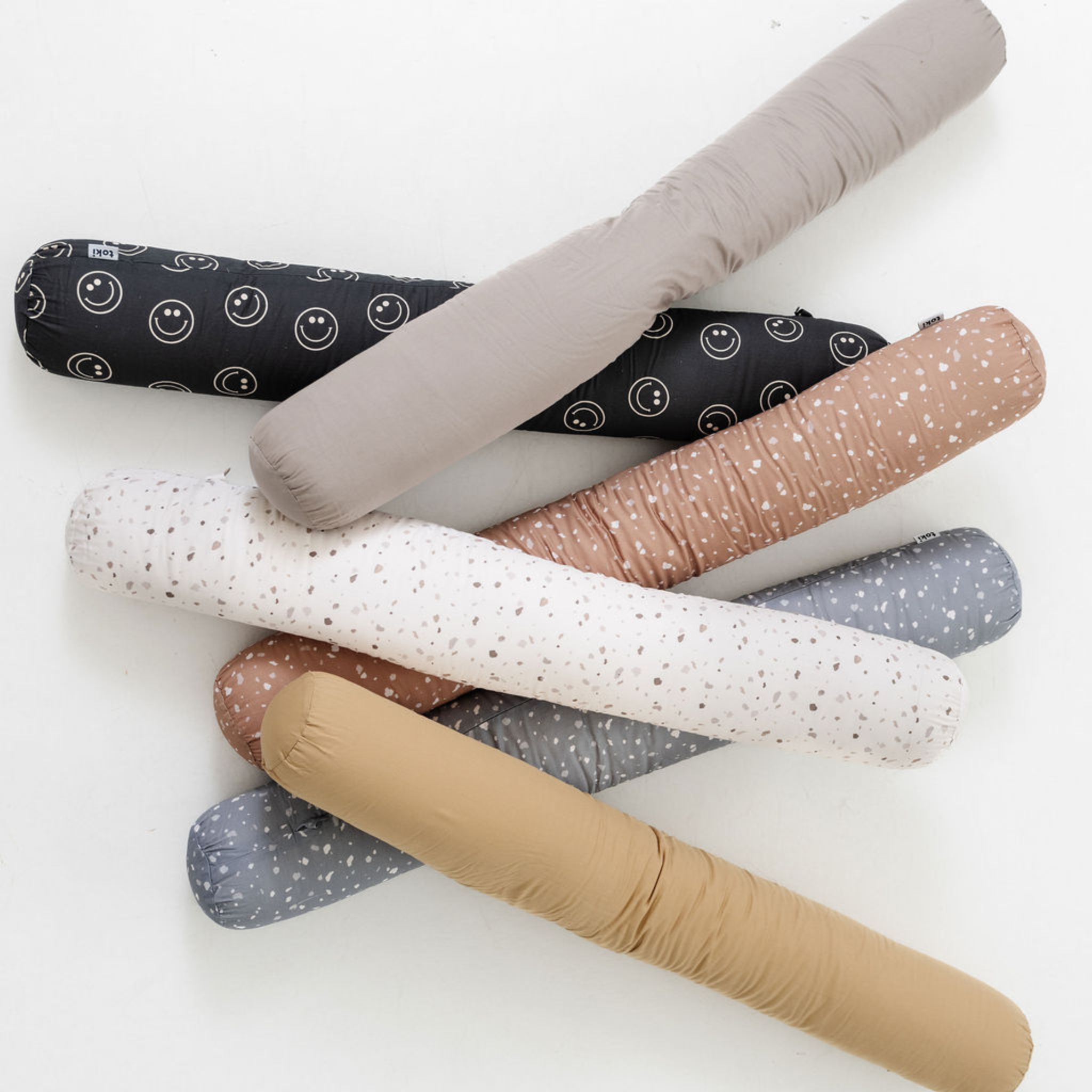 Set of colorful rolling pins with different patterns on a white background