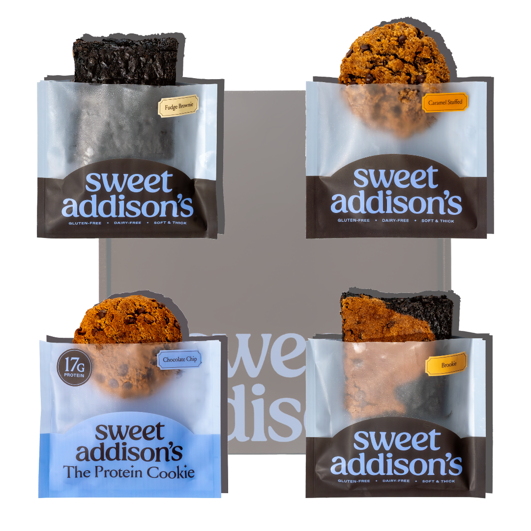Four packages of Sweet Addison's protein cookies on a white background