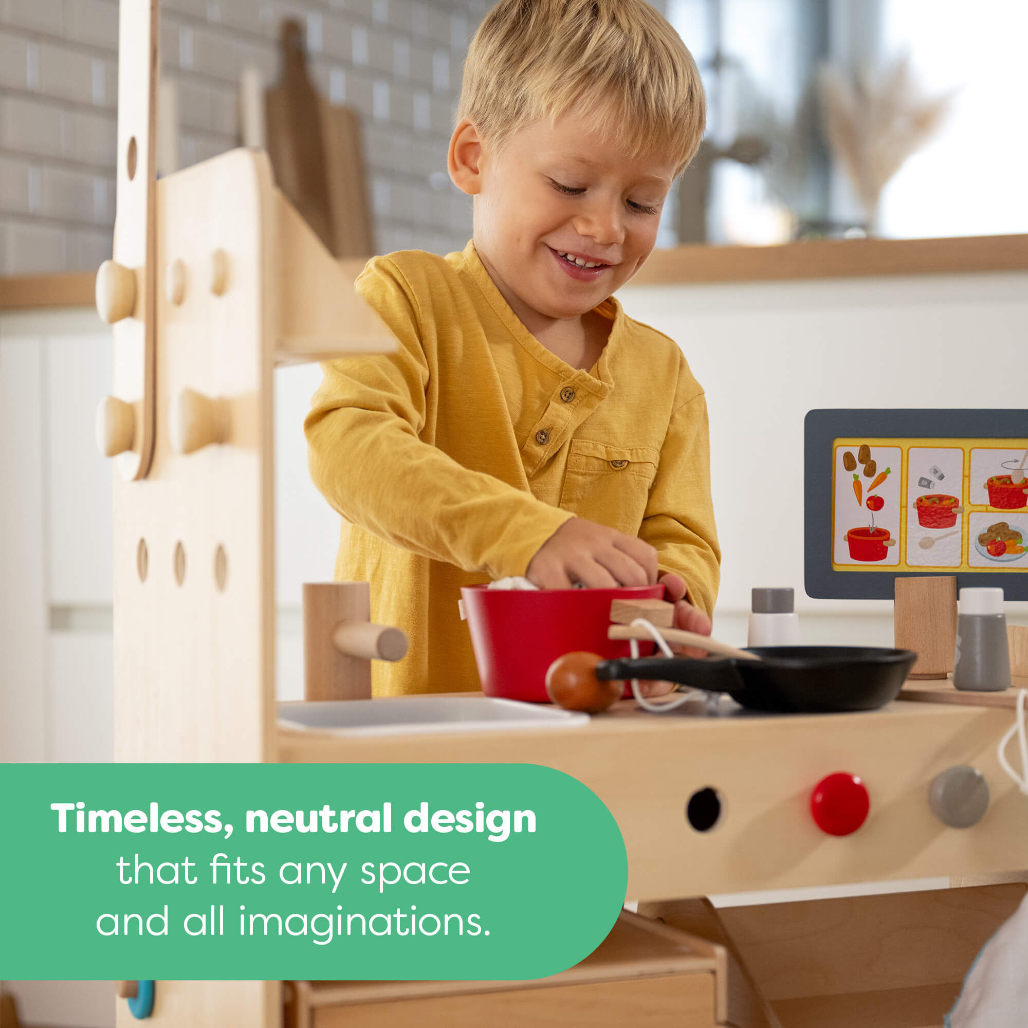 Child playing with a wooden play kitchen set in a neutral-colored room.