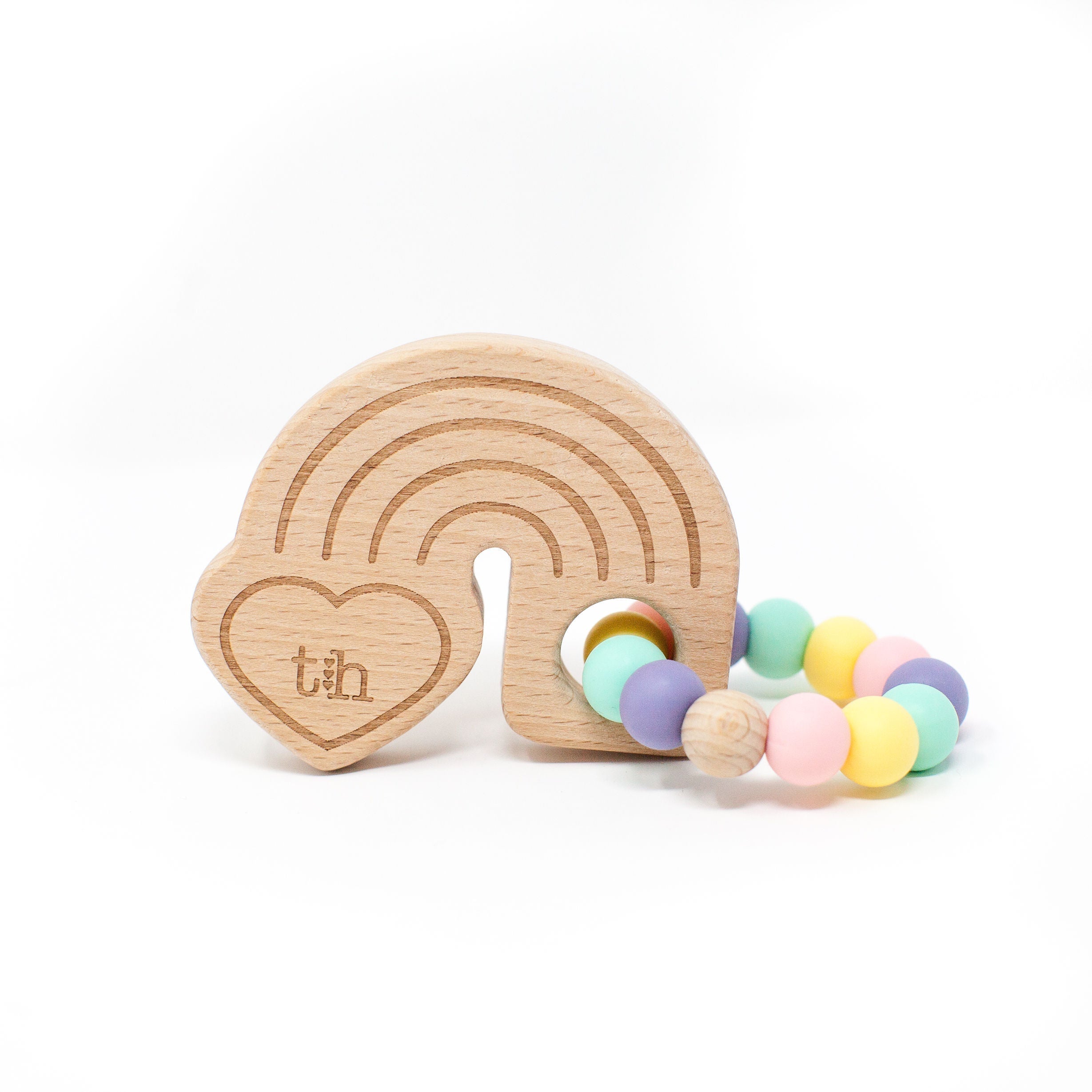 Wooden teething ring with colorful beads on a white background