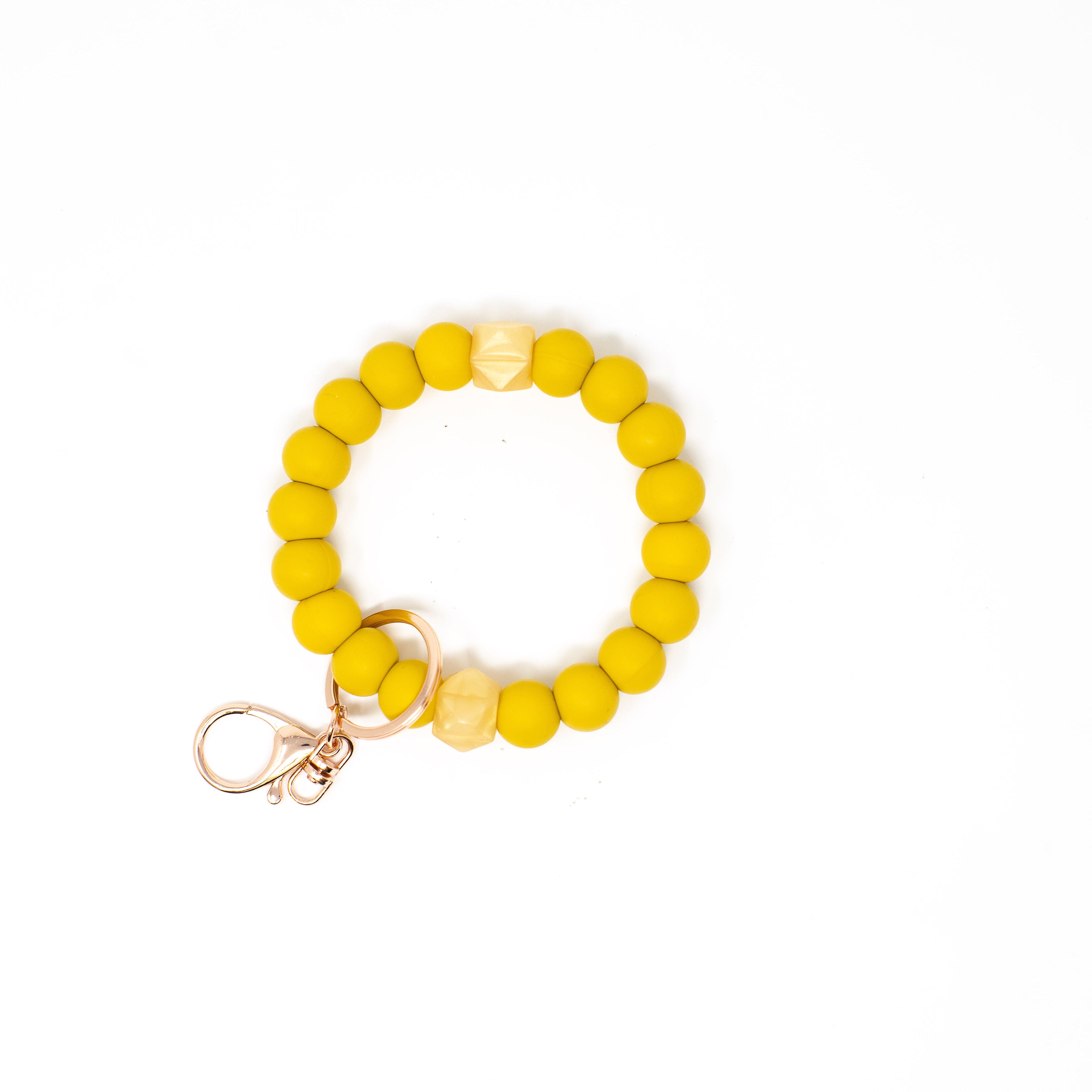 Yellow beaded bracelet with a keychain on a white background