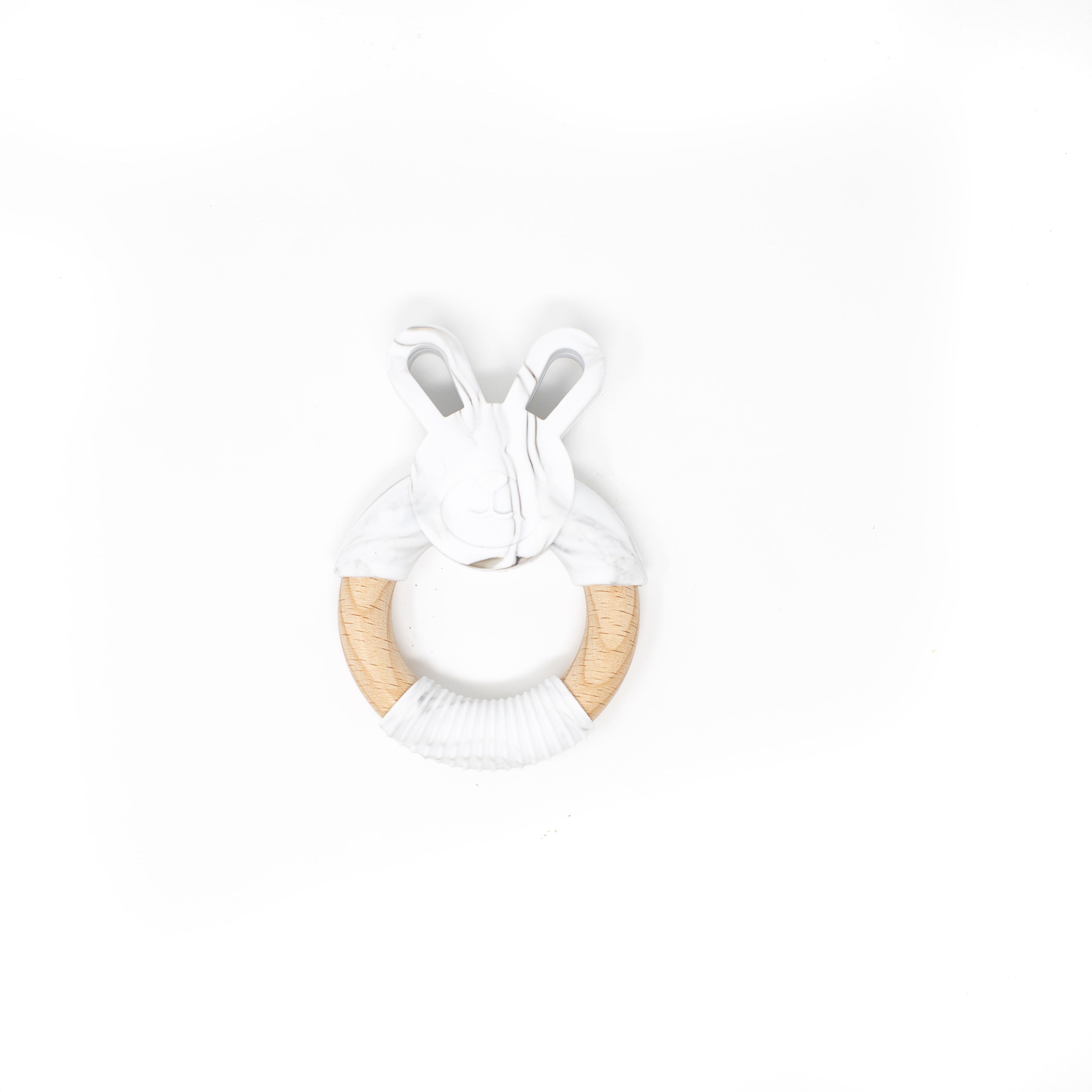 White bunny-shaped teether with wooden ring on a white background