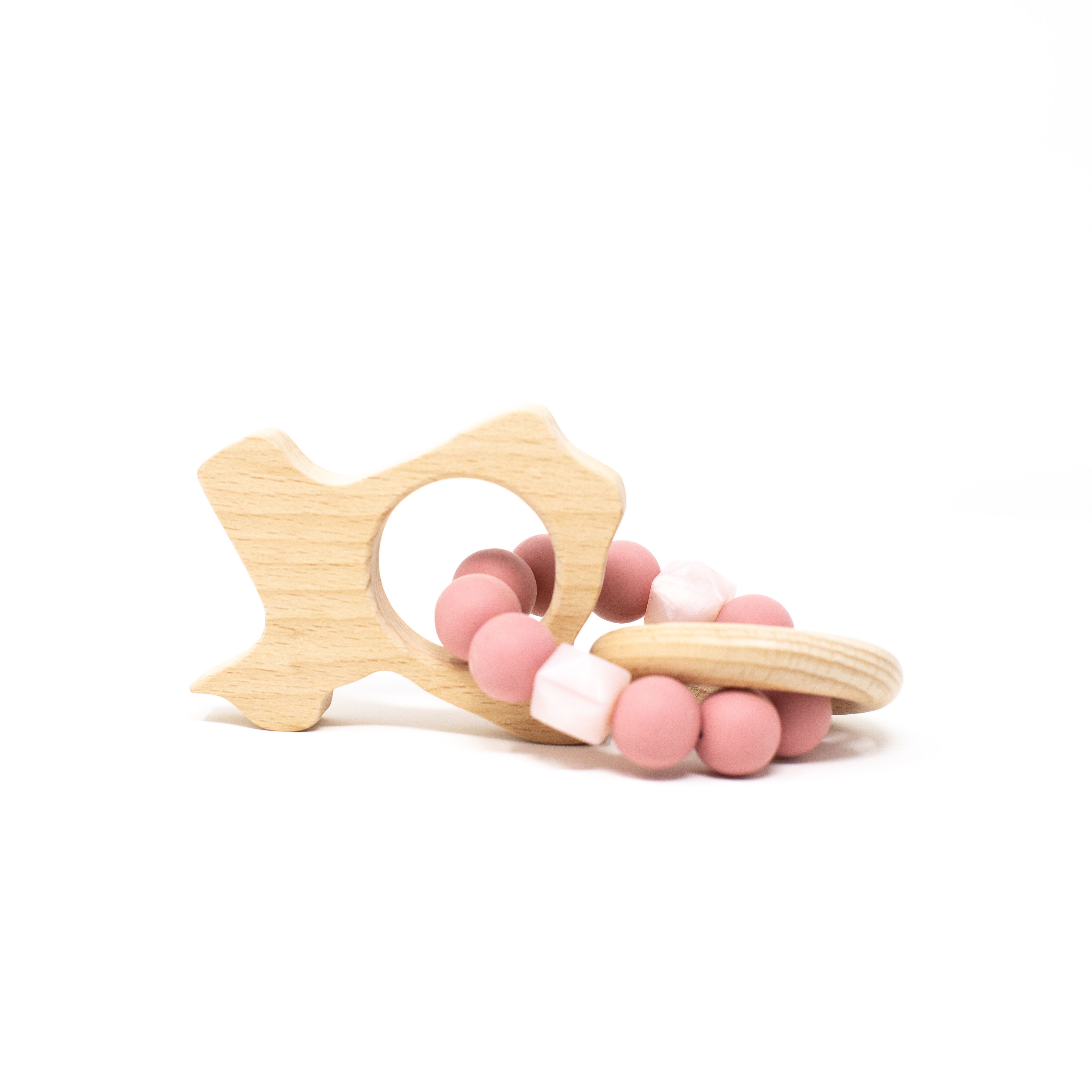 Wooden teething ring with pink and white beads on a white background