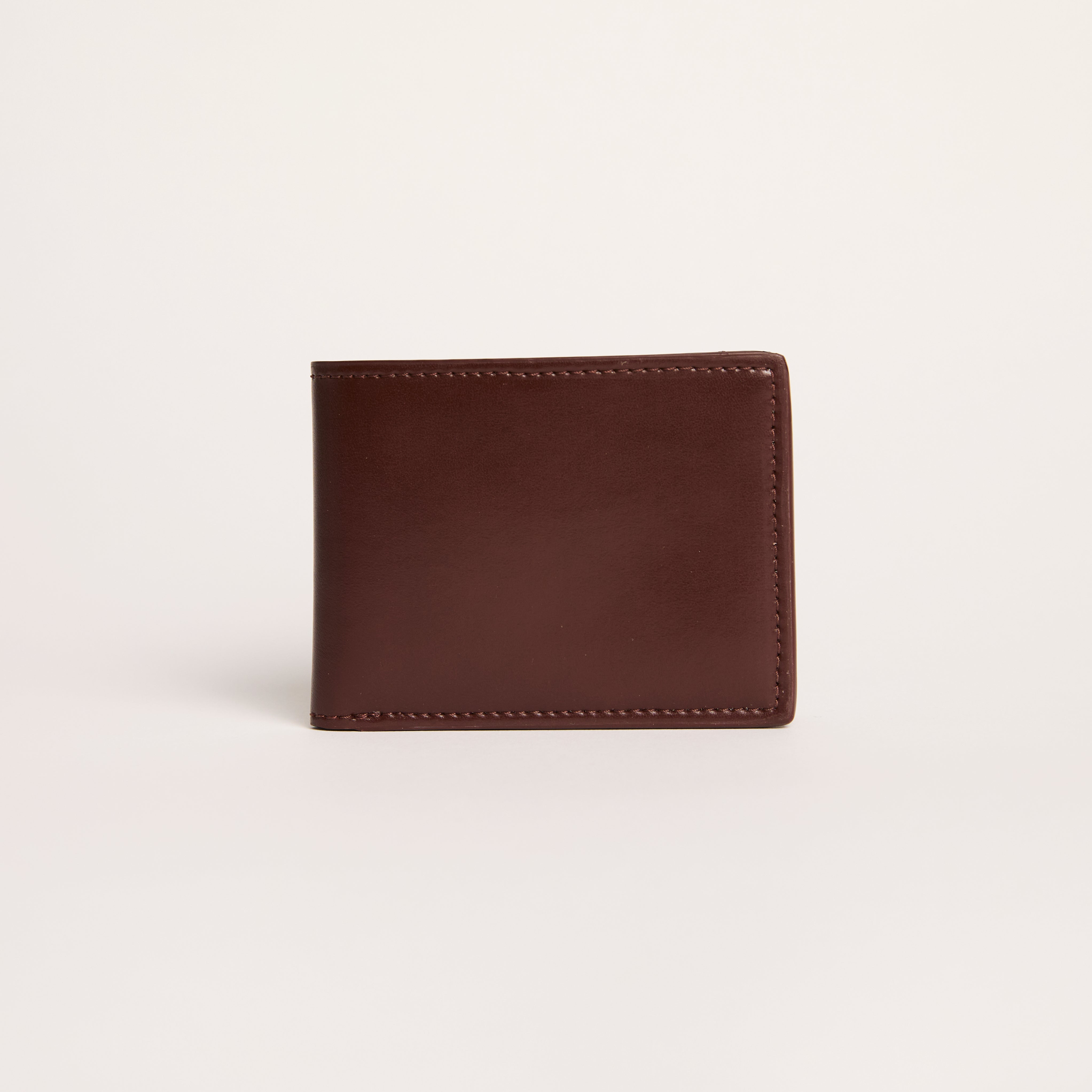 Brown leather wallet on a light beige background
