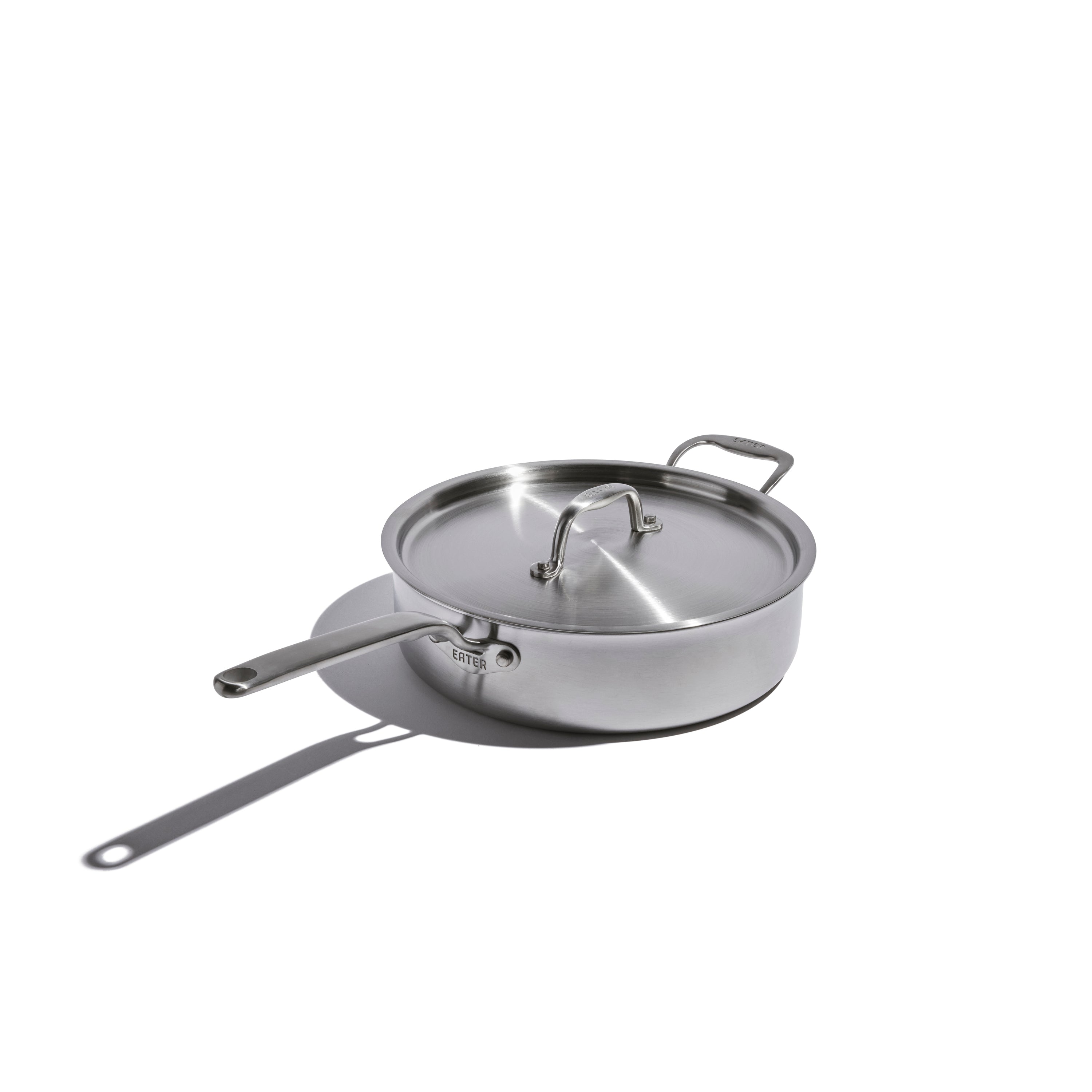 Stainless steel frying pan with lid on a white background