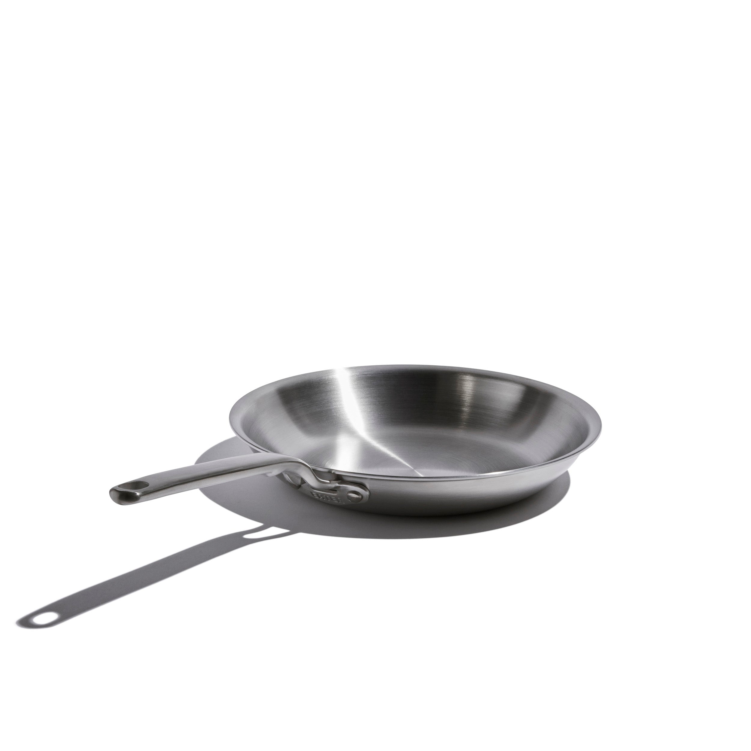 Stainless steel frying pan on a white background