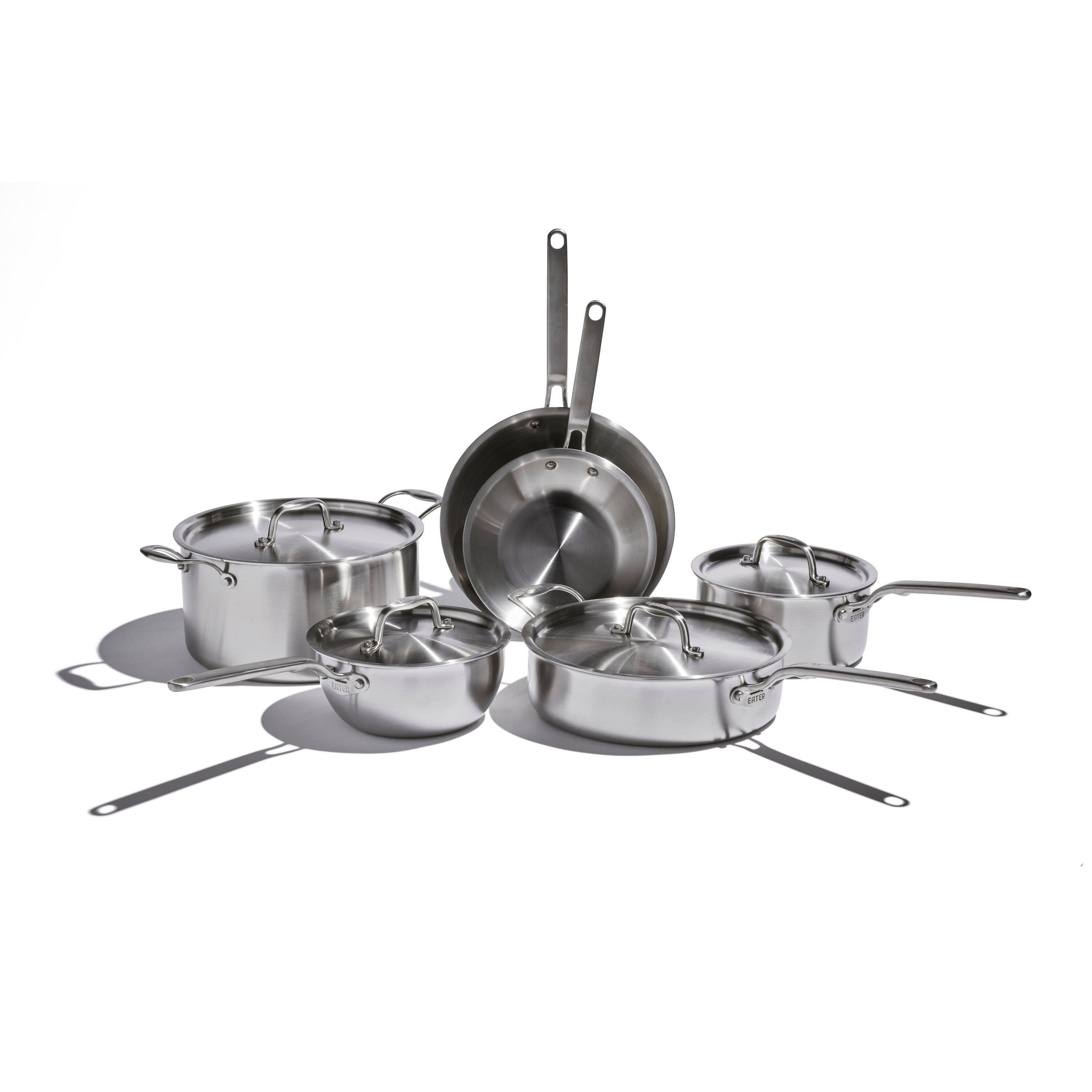 Set of stainless steel cookware on a white background