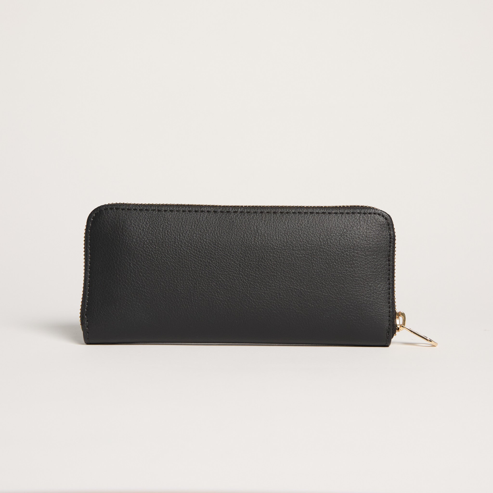 Black wallet with a gold zipper on a light gray background