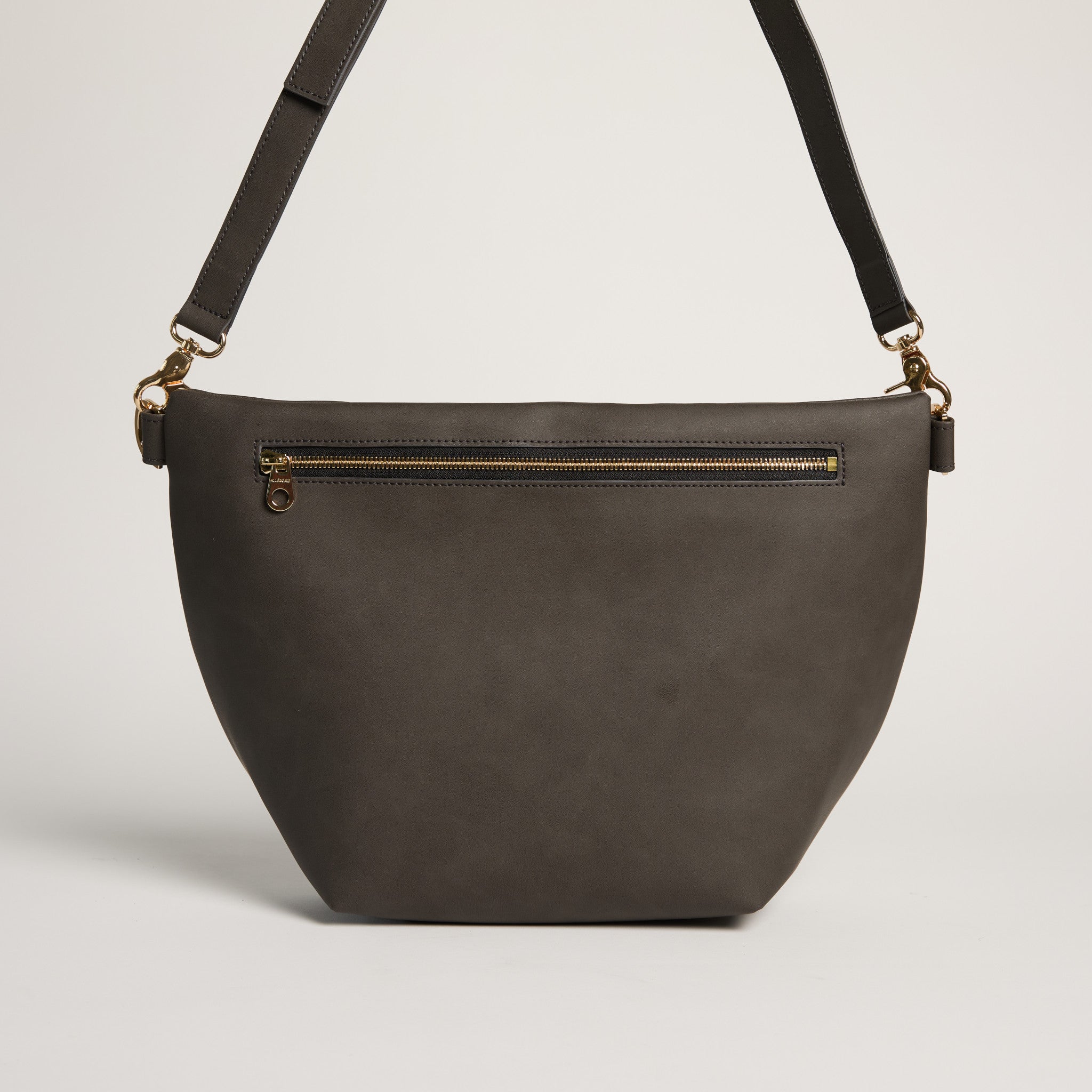 Dark brown leather handbag with gold zipper on a light gray background