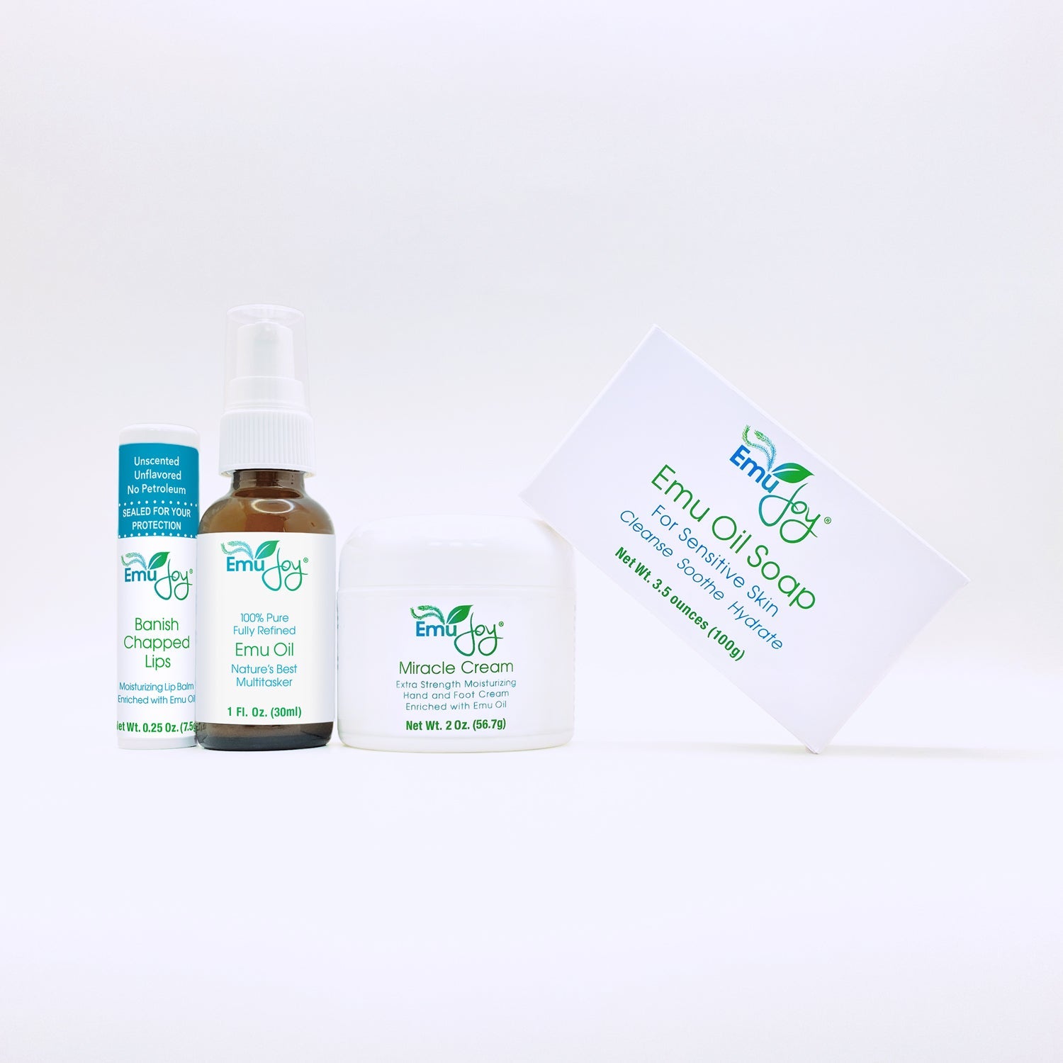 Collection of Emu Oil products including a bottle, cream, and soap on a white background