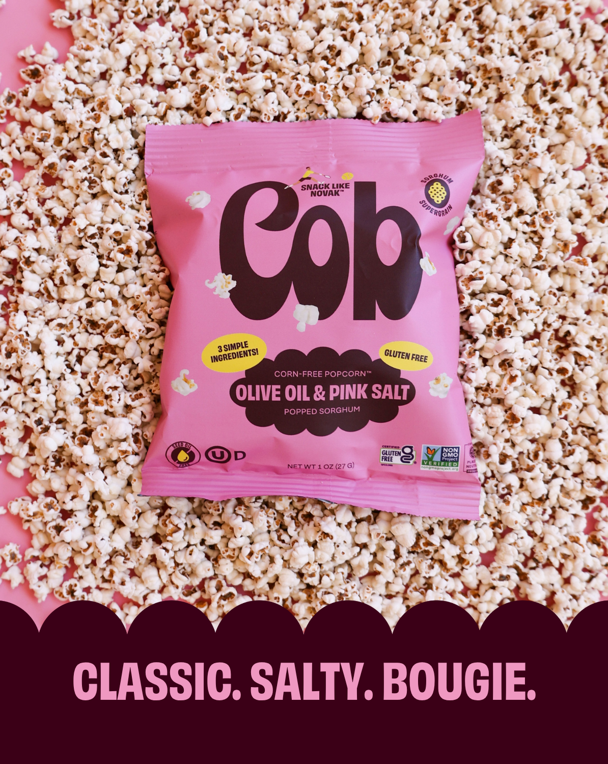 Pink 'Cob' popcorn bag on a bed of popcorn with text 'Classic. Salty. Bougie.'