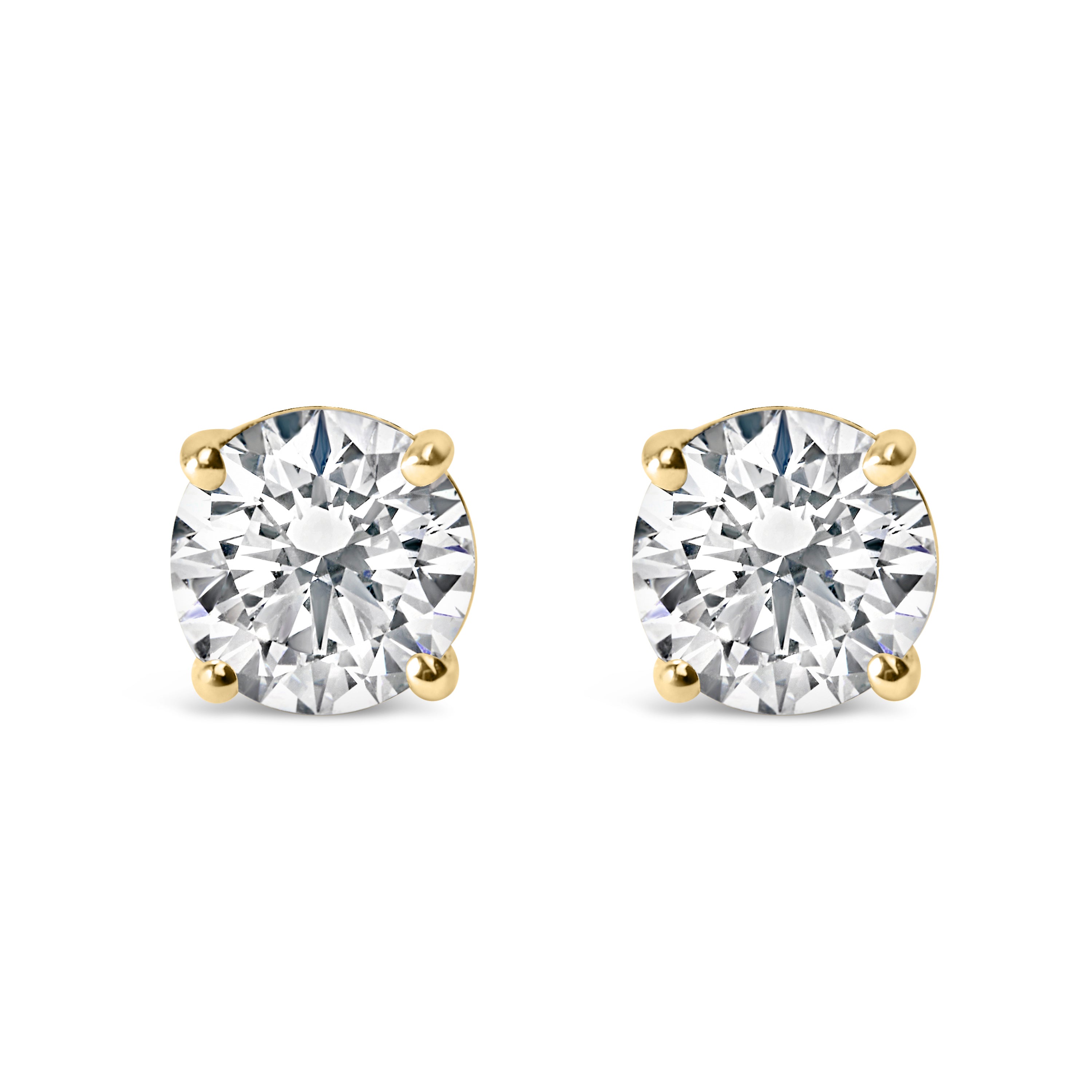 Pair of gold stud earrings with clear gemstones on a white background