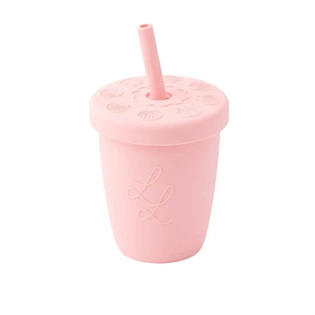 Pink silicone cup with straw on a white background