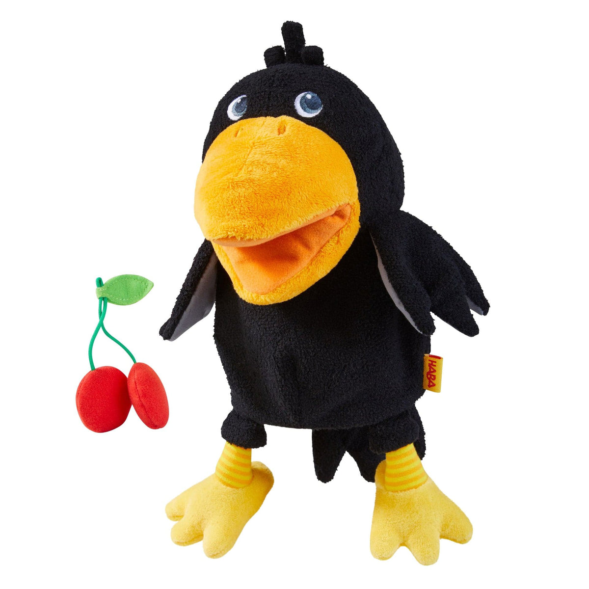 Plush toy raven with a cherry on a white background