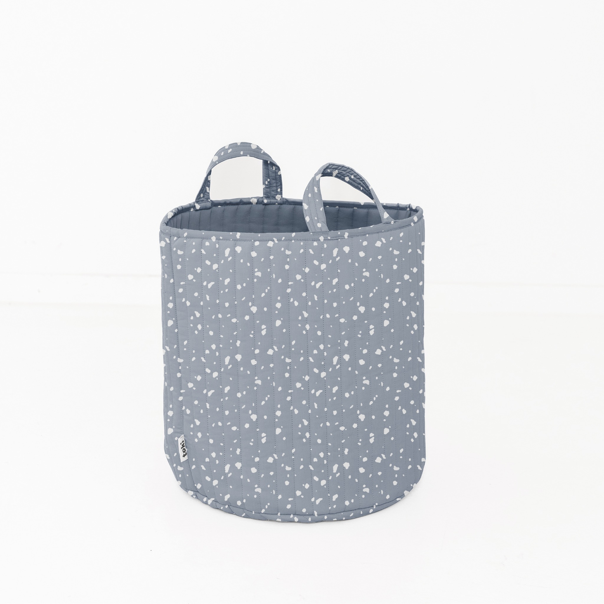 Gray fabric storage basket with white speckles on a white background