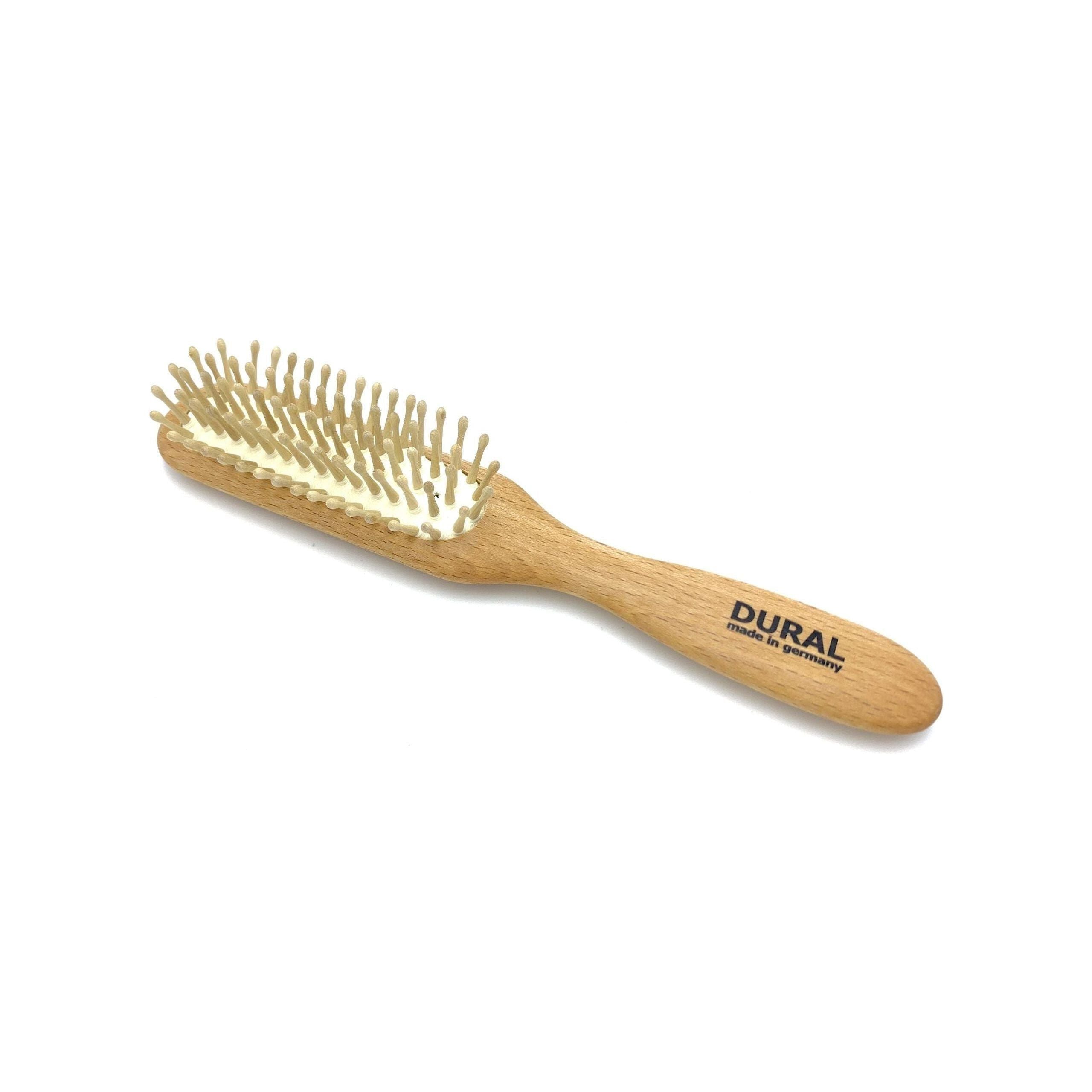 Wooden hairbrush with bristles on a white background, featuring the brand 'DURAL'.
