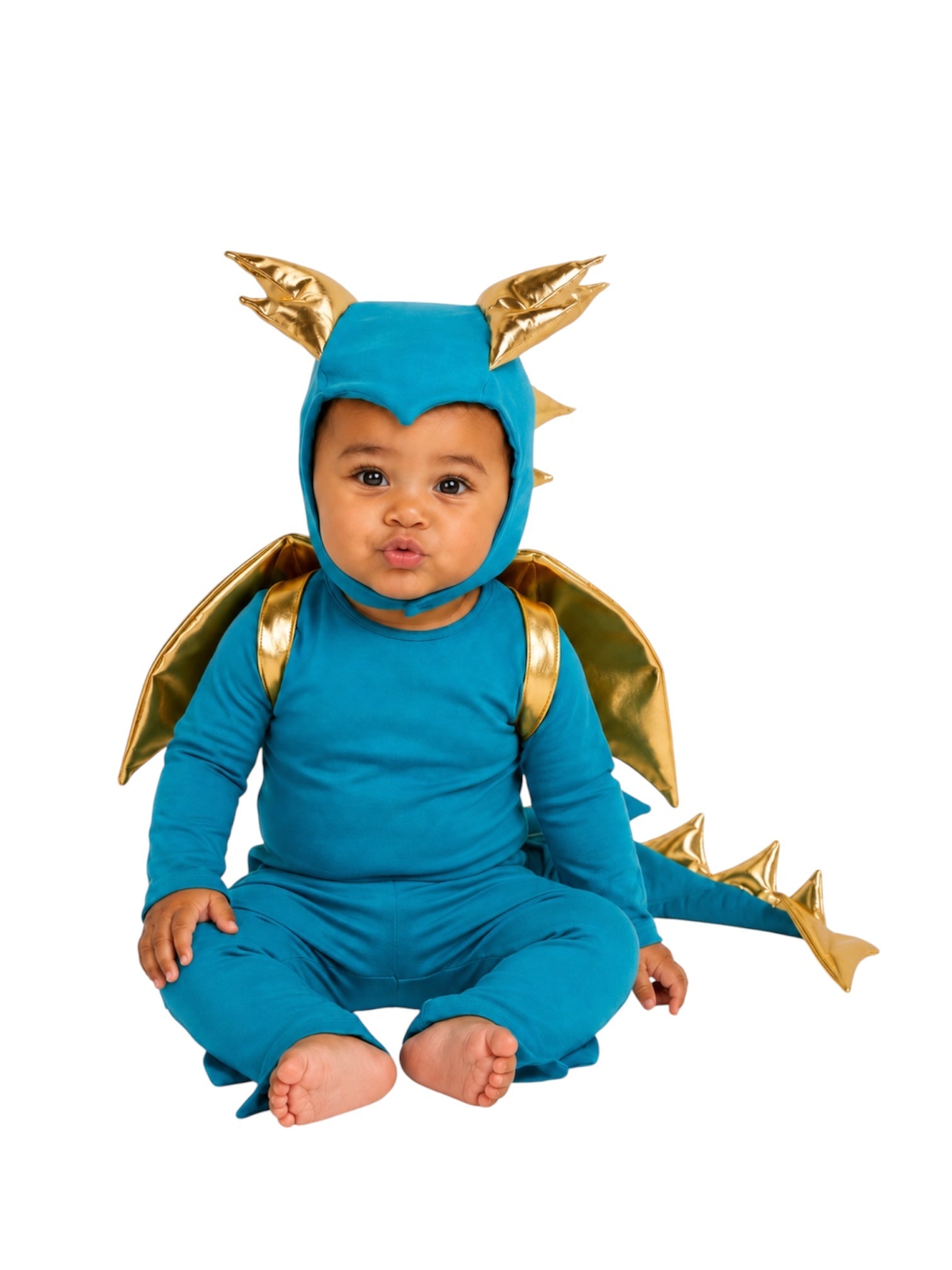 A baby wearing a blue dragon costume with gold wings, gold spikes, and a gold horned hood, sitting against a plain white background.