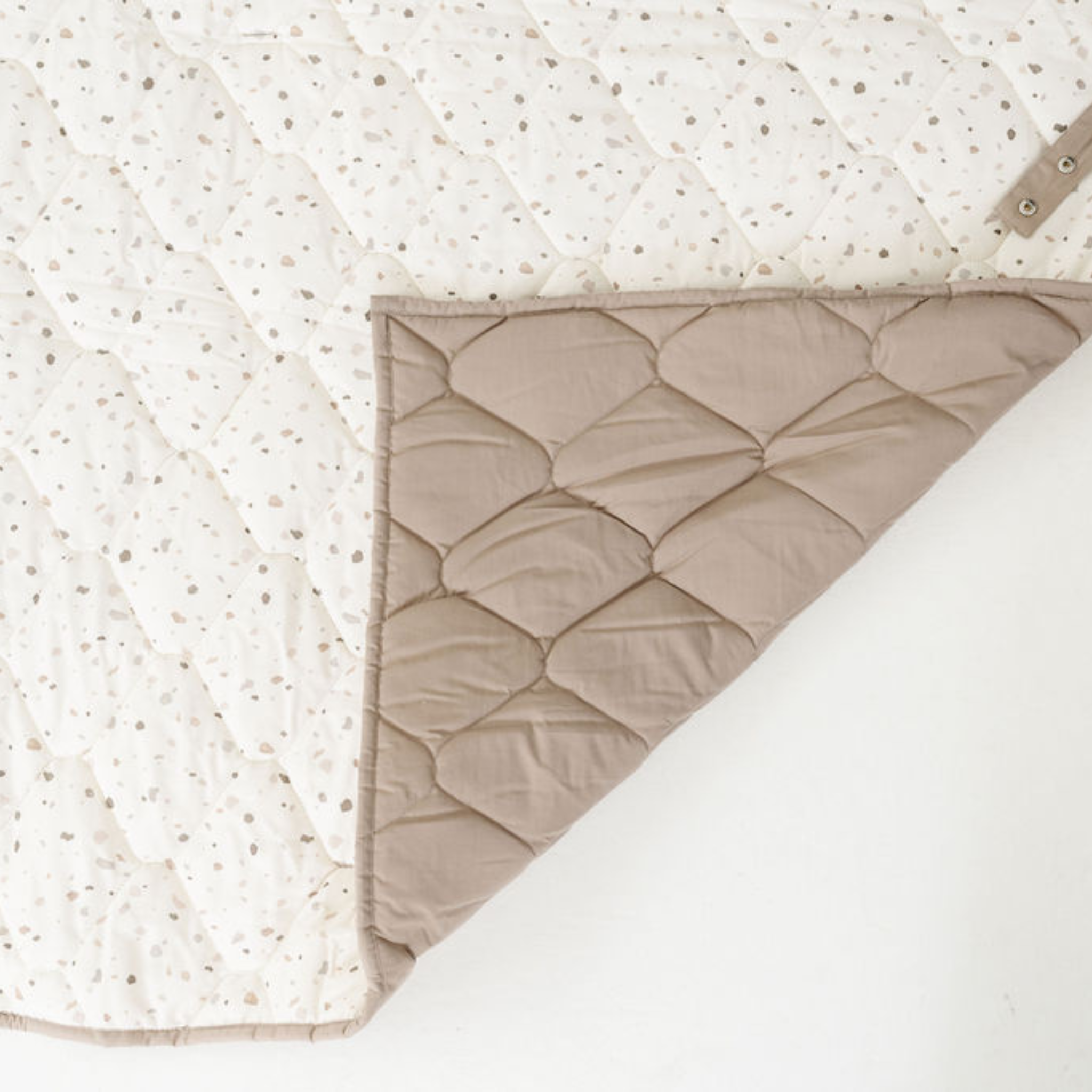 Quilted blanket with textured surface on a white background