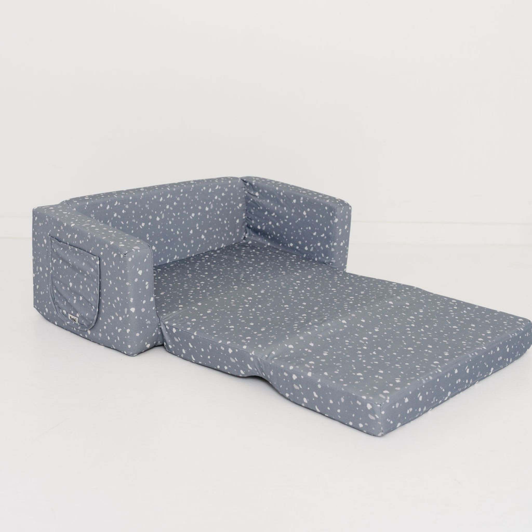 Gray pet bed with white polka dots on a light gray background
