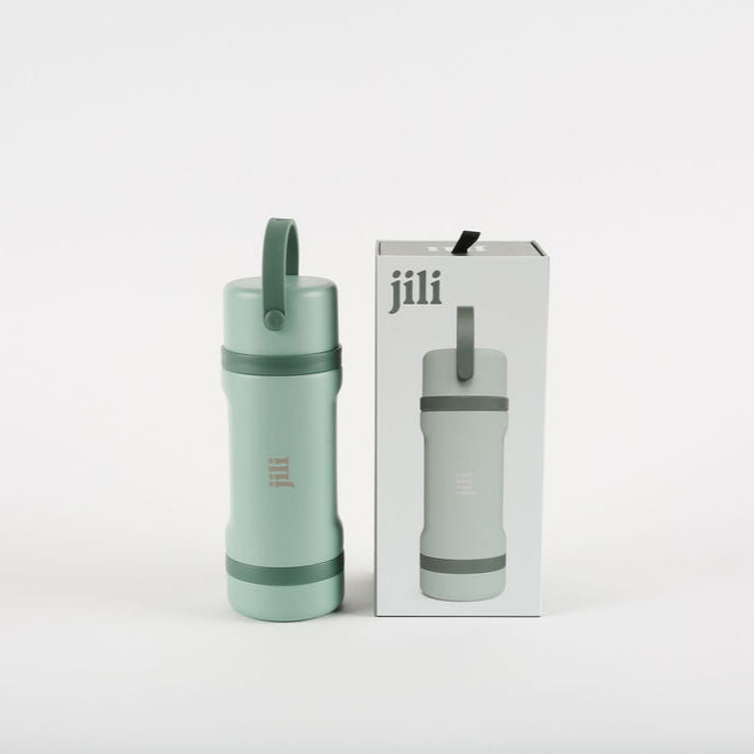 Mint green water bottle with carrying strap and matching packaging on a white background