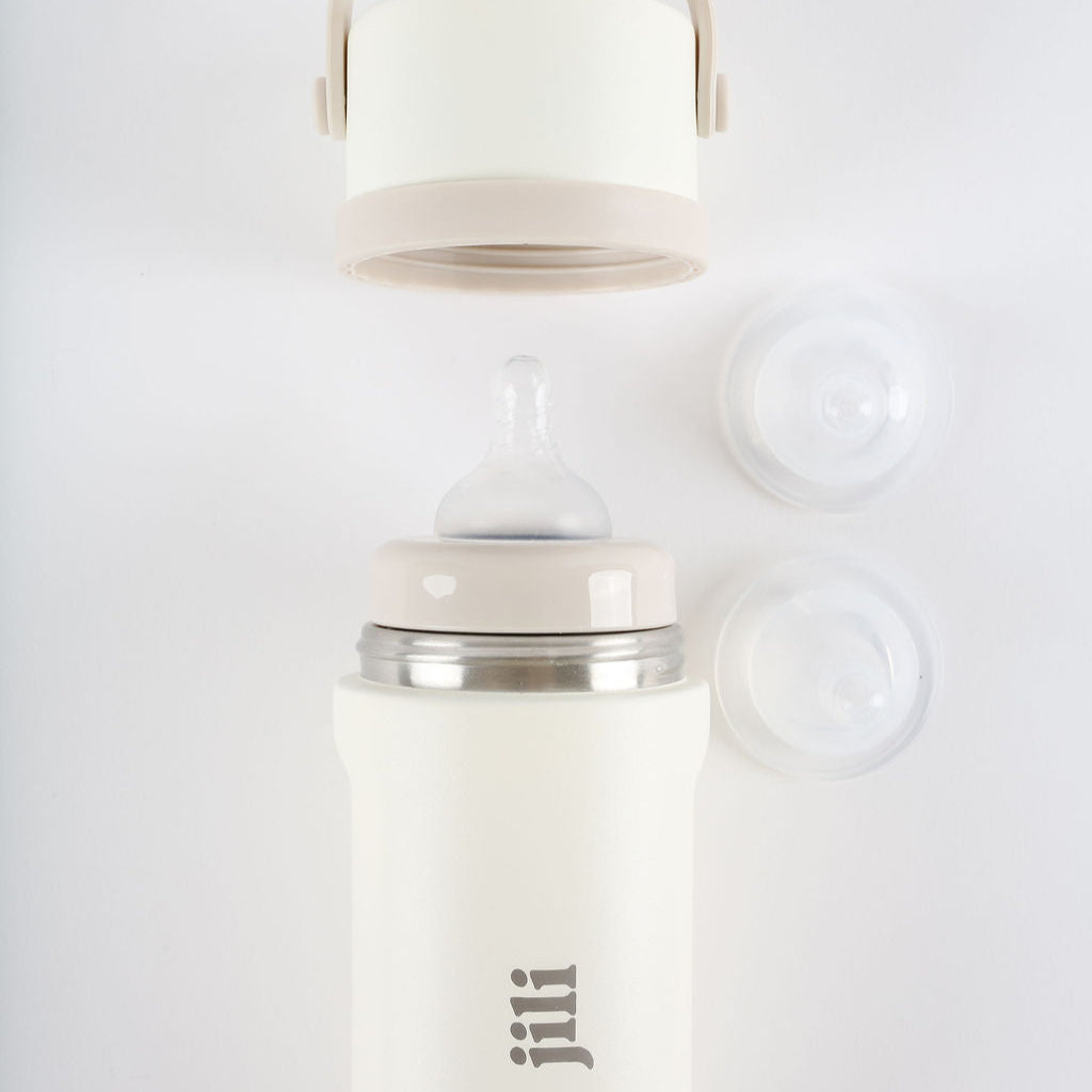 White bottle with silver cap on a light gray background