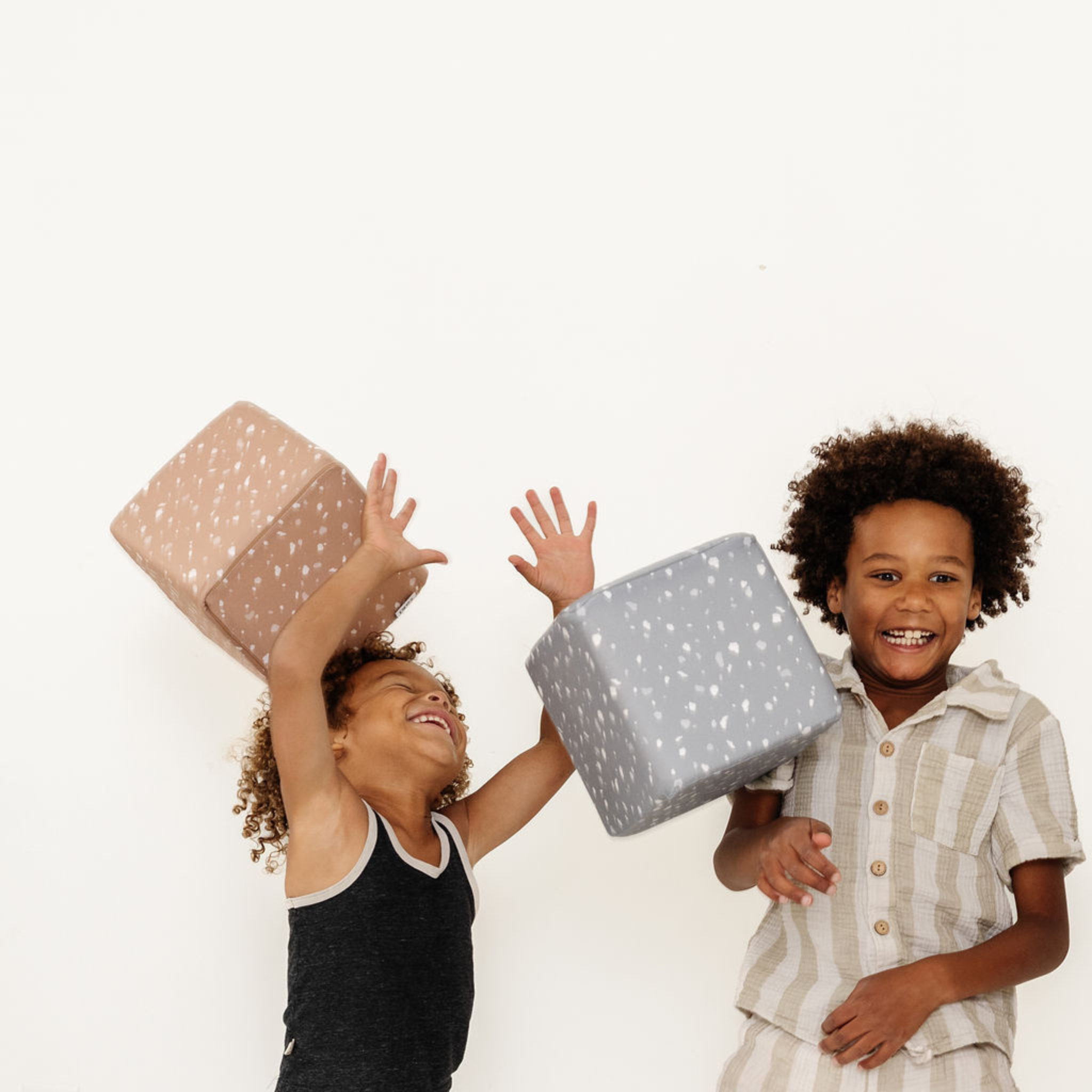 Two children holding gift boxes against a white background