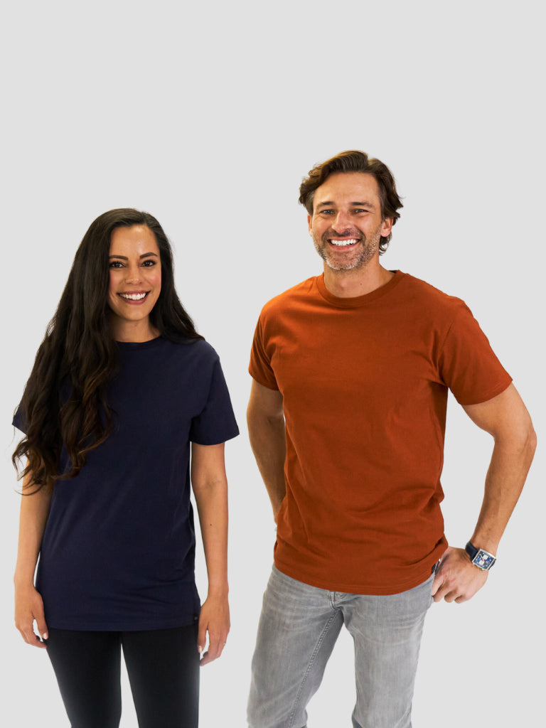 Two people wearing plain t-shirts against a light gray background