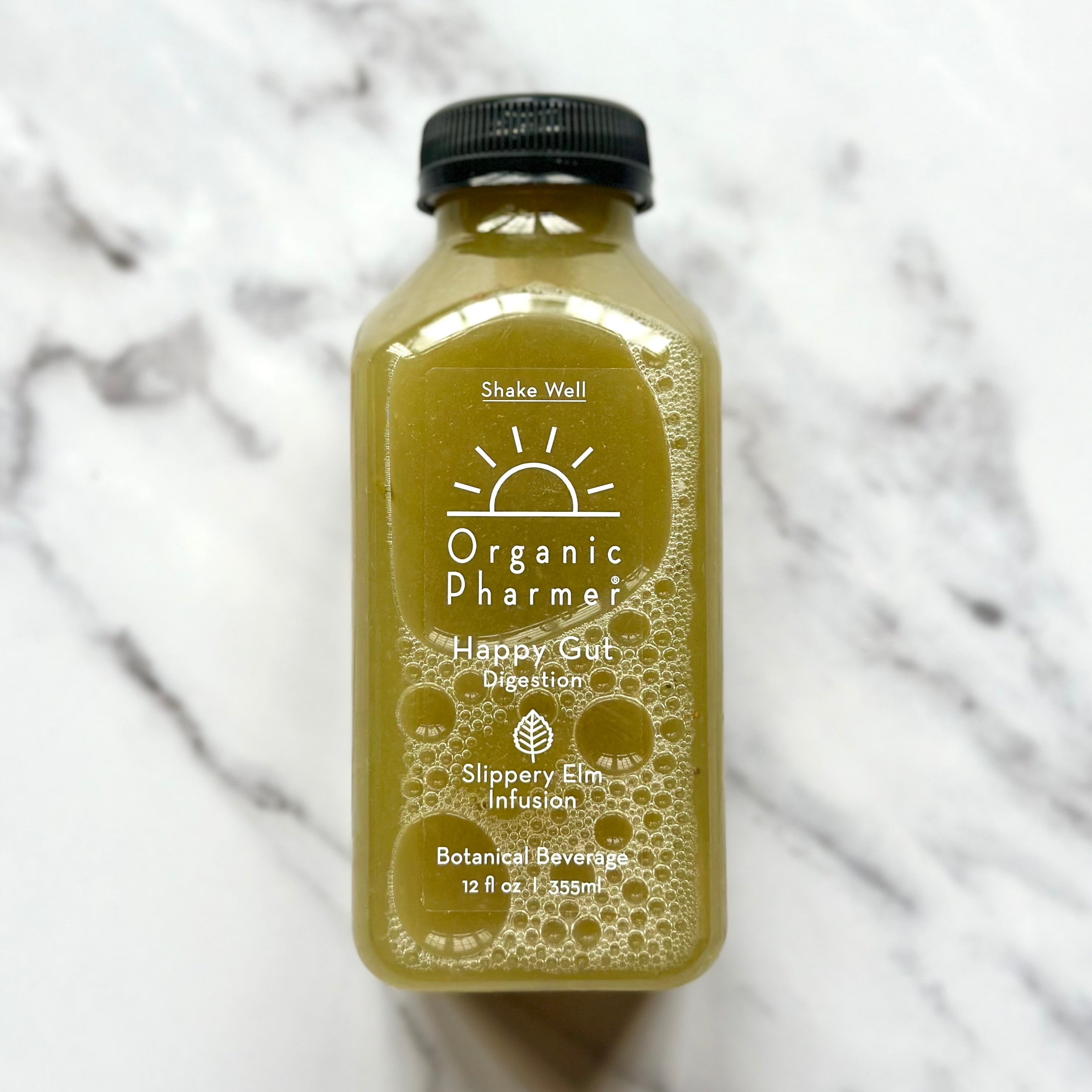 Bottle of Organic Pharmer botanical beverage on a marble background