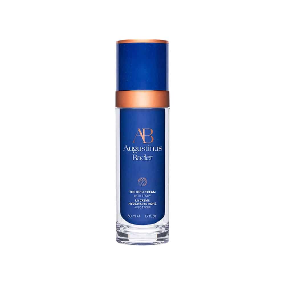 Blue skincare bottle with gold accents on a white background