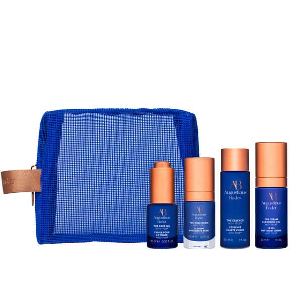 Set of skincare products with a blue mesh pouch on a white background