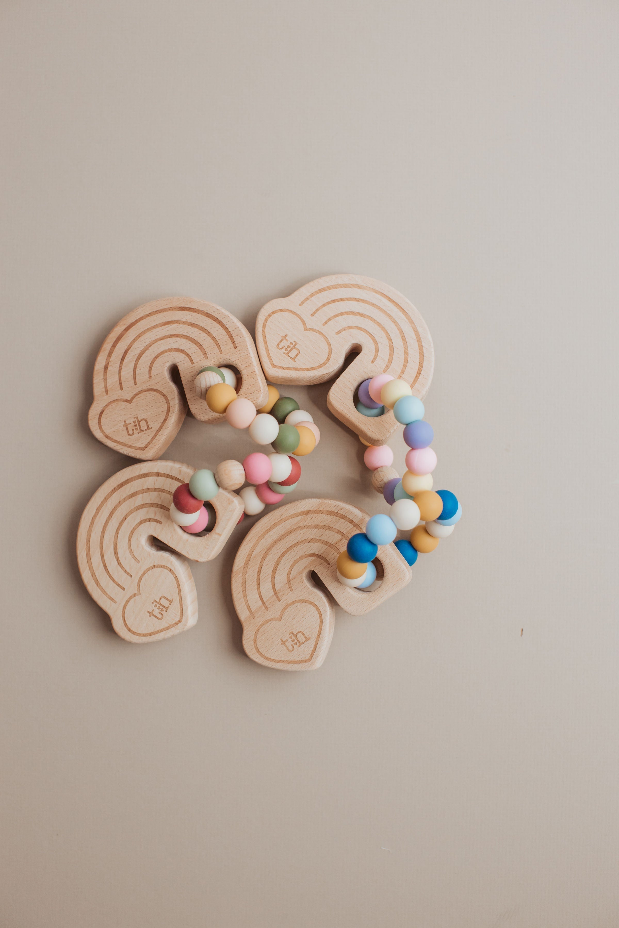 Wooden toy with colorful beads on a beige background