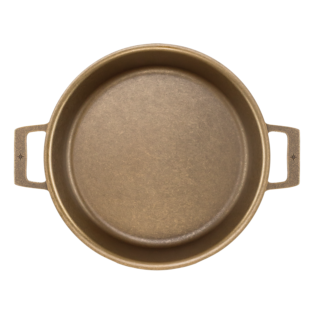 Bronze round baking dish with handles on a white background