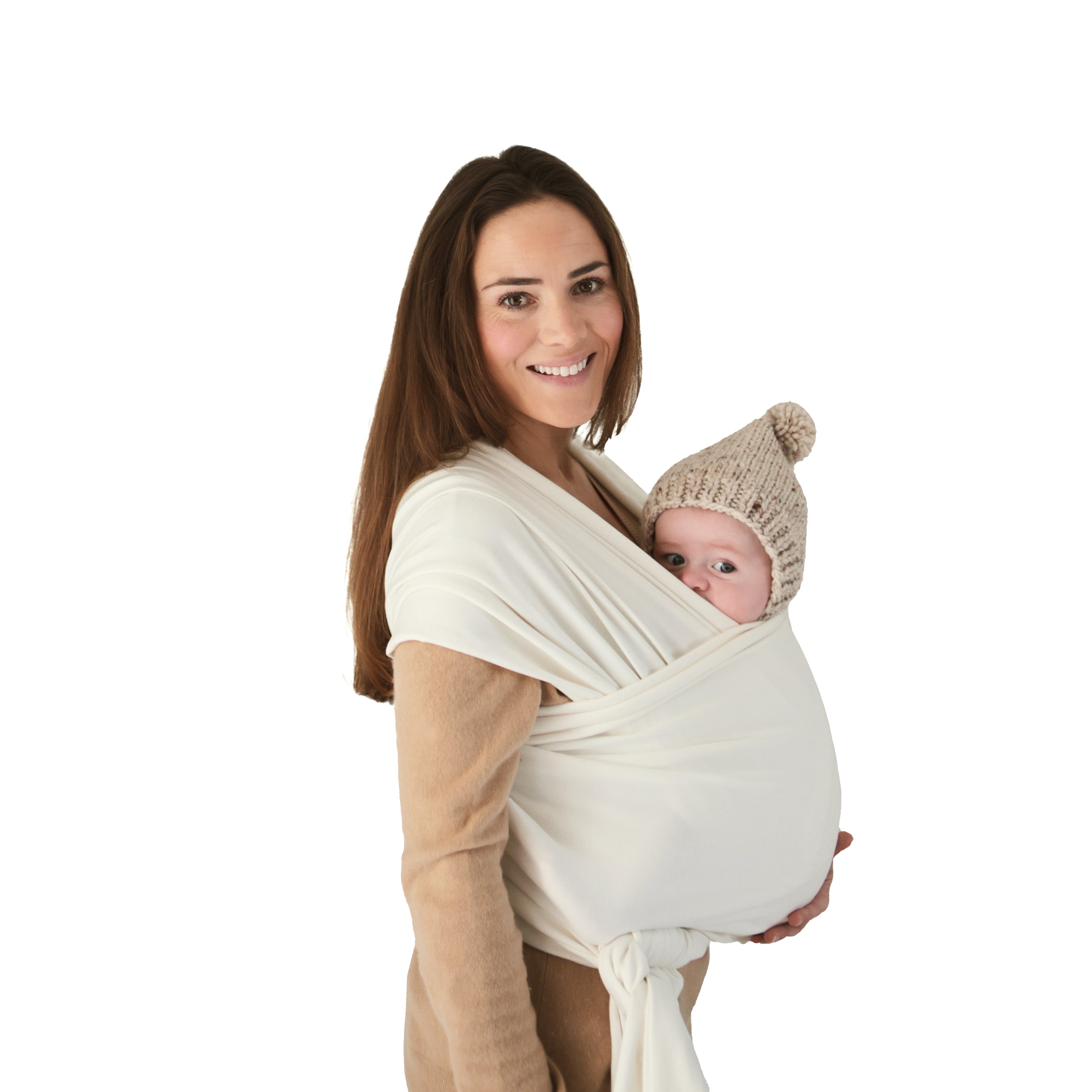 Woman holding a baby in a white wrap against a white background