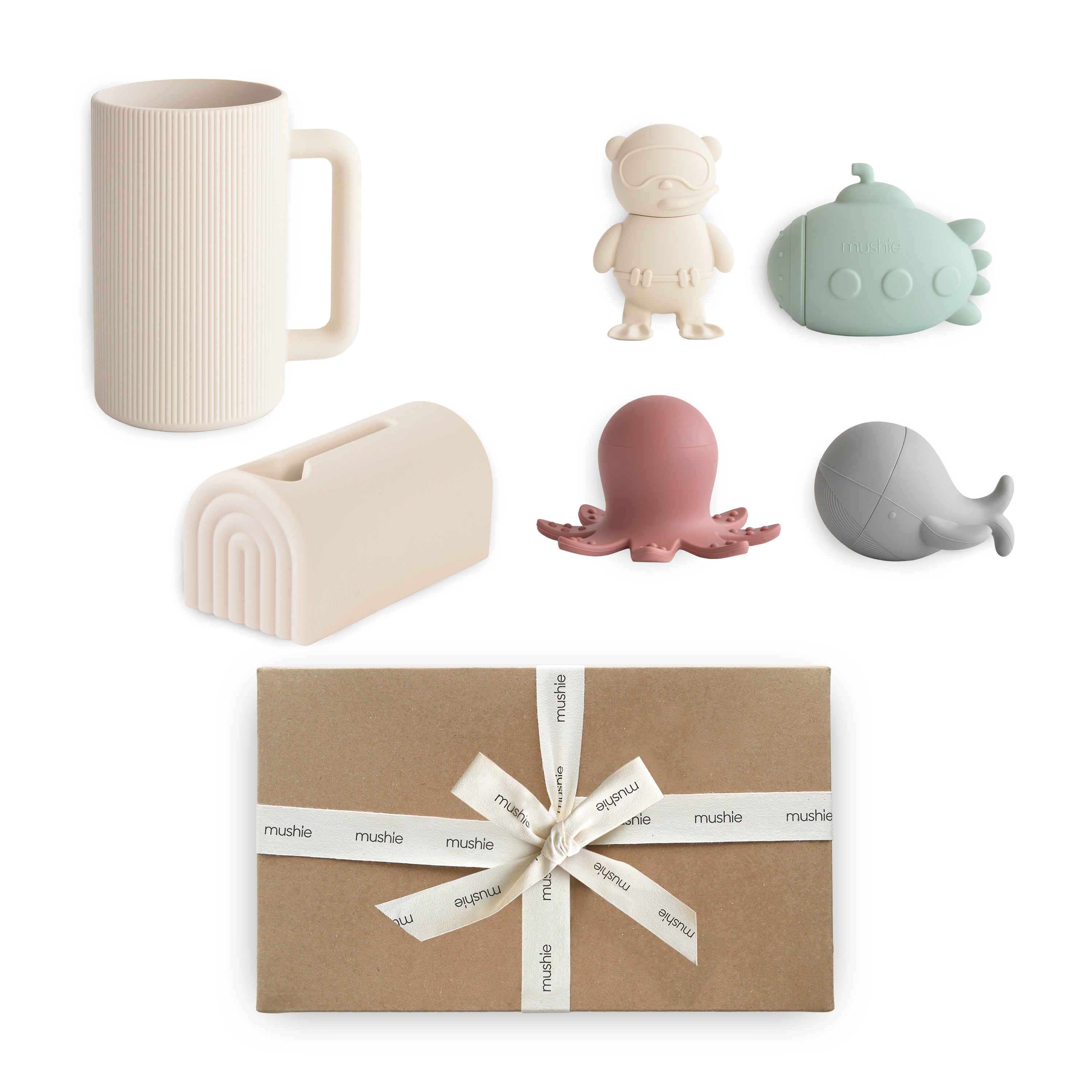 Set of decorative items including a mug, bear figurine, whale, and octopus on a white background with a wrapped gift box.