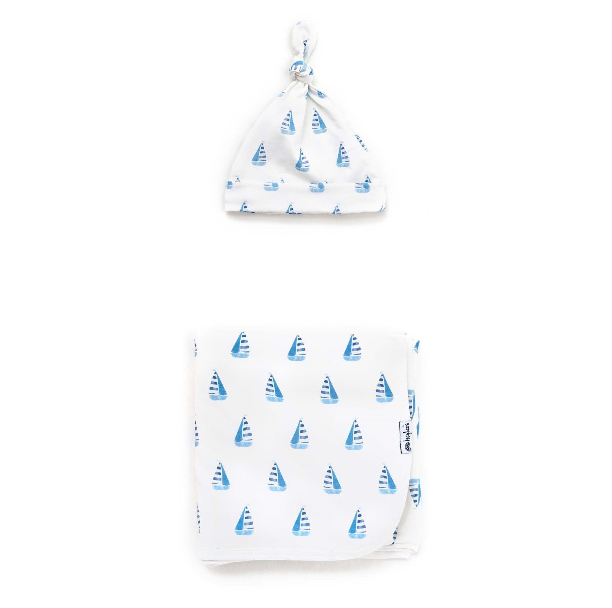 Baby hat and swaddle with sailboat pattern on a white background