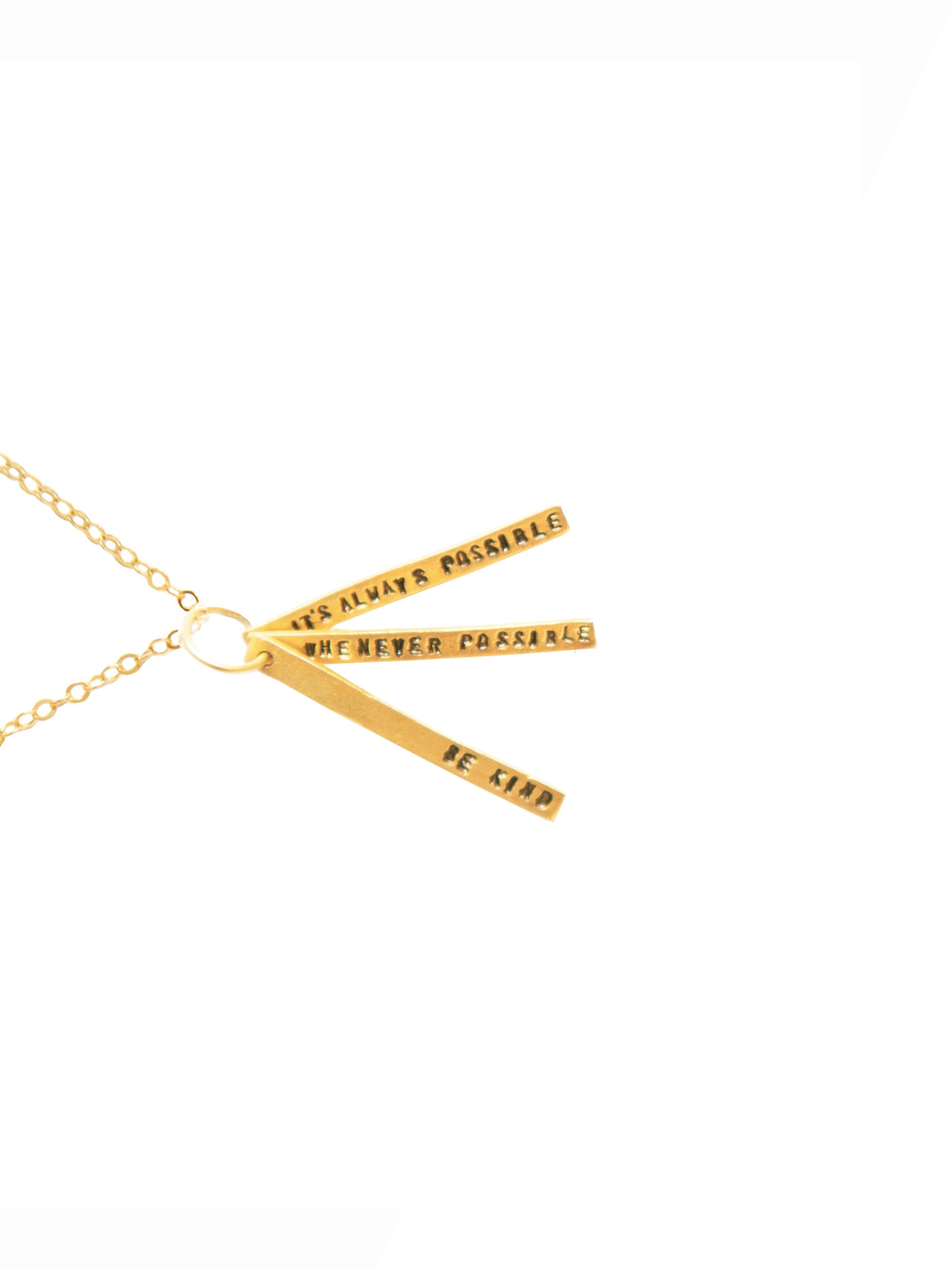 Gold necklace with three interlocking rings on a white background