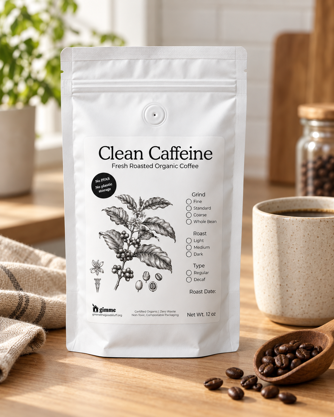 White Clean Caffeine coffee bag with botanical label standing on a light stone countertop beside a ceramic mug of coffee and scattered coffee beans in a bright, airy kitchen.