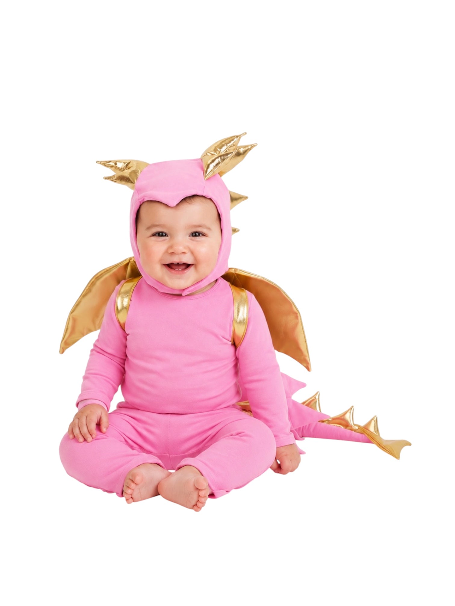 A baby wearing a pink dragon costume with gold wings, horns, and tail spikes, sitting against a plain white background.