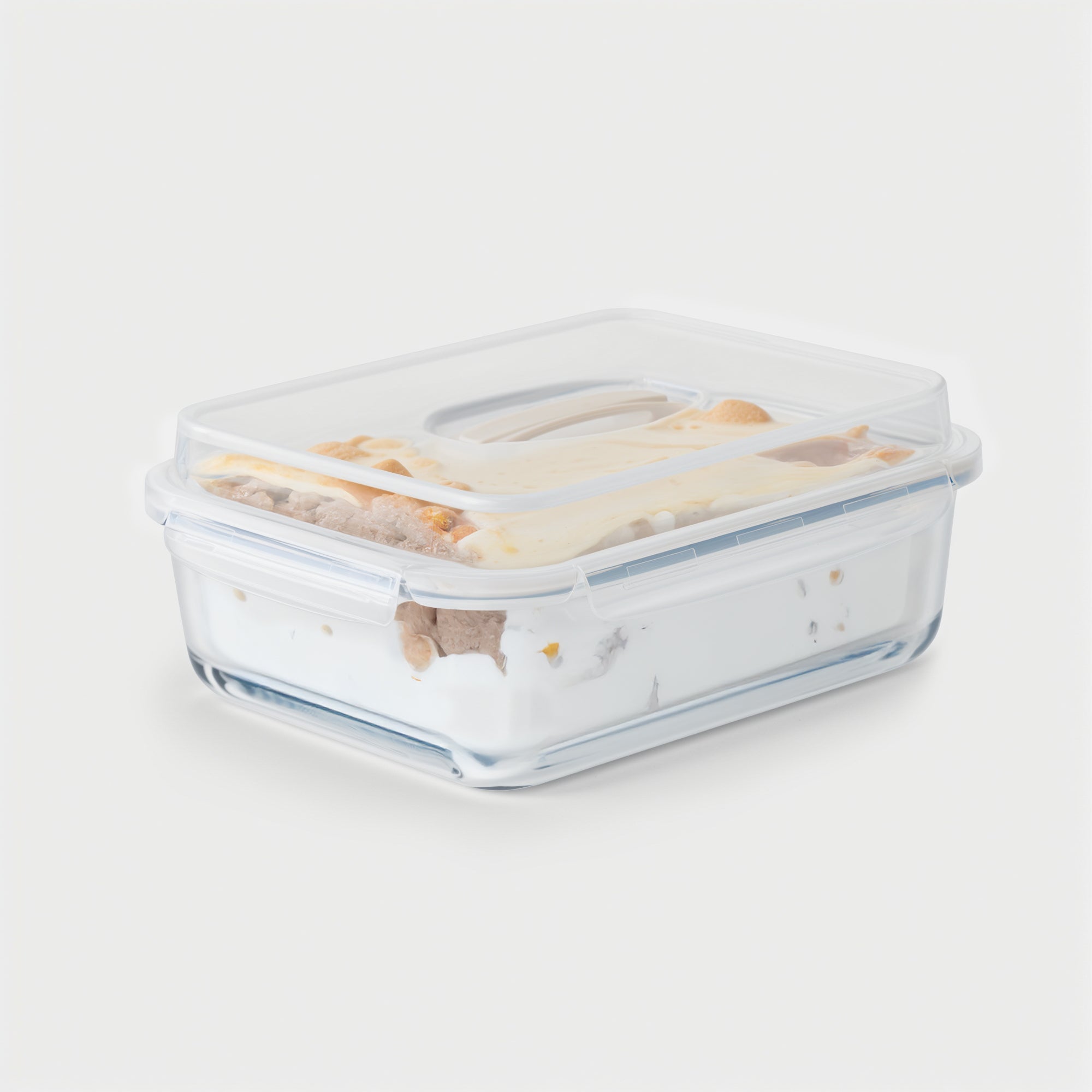 Clear glass food storage container with a lid on a white background