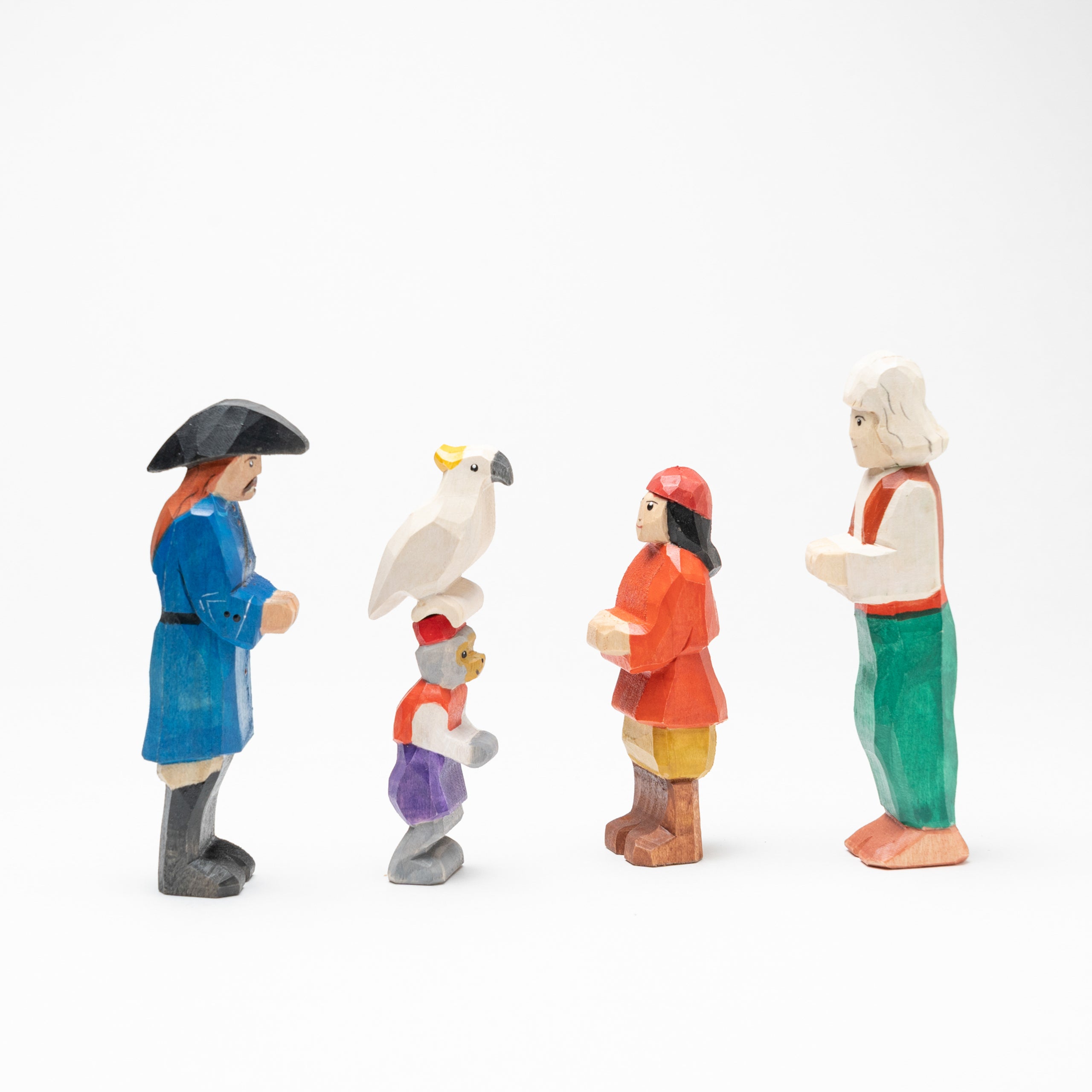 Set of miniature figurines with colorful clothing and accessories on a white background