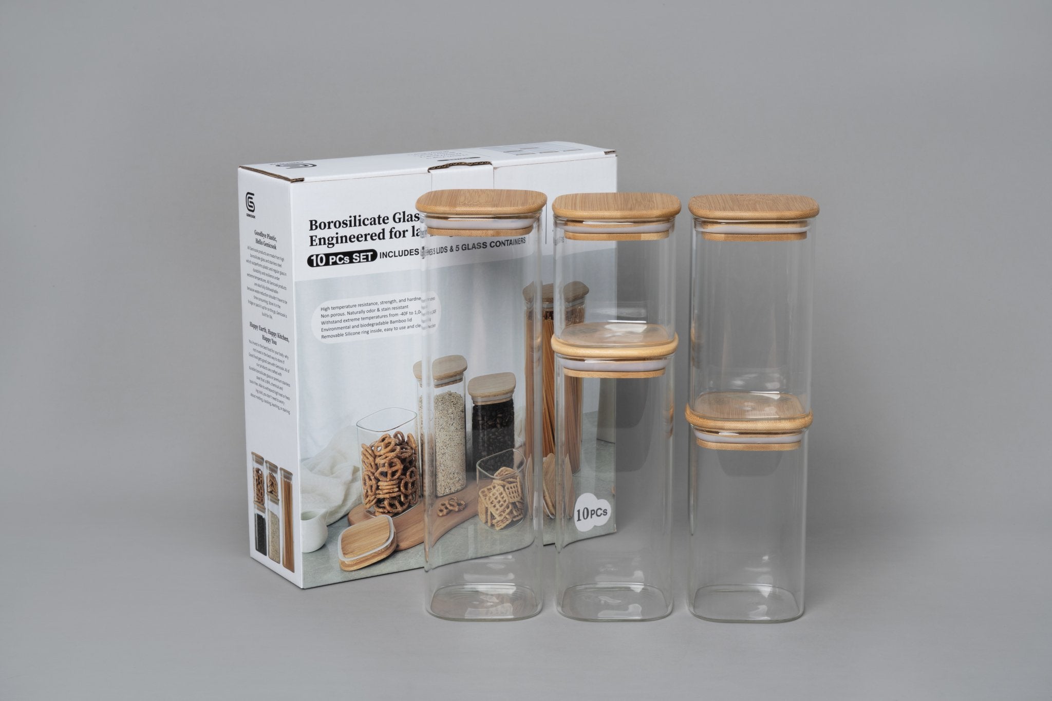 Set of glass jars with wooden lids and packaging on a gray background